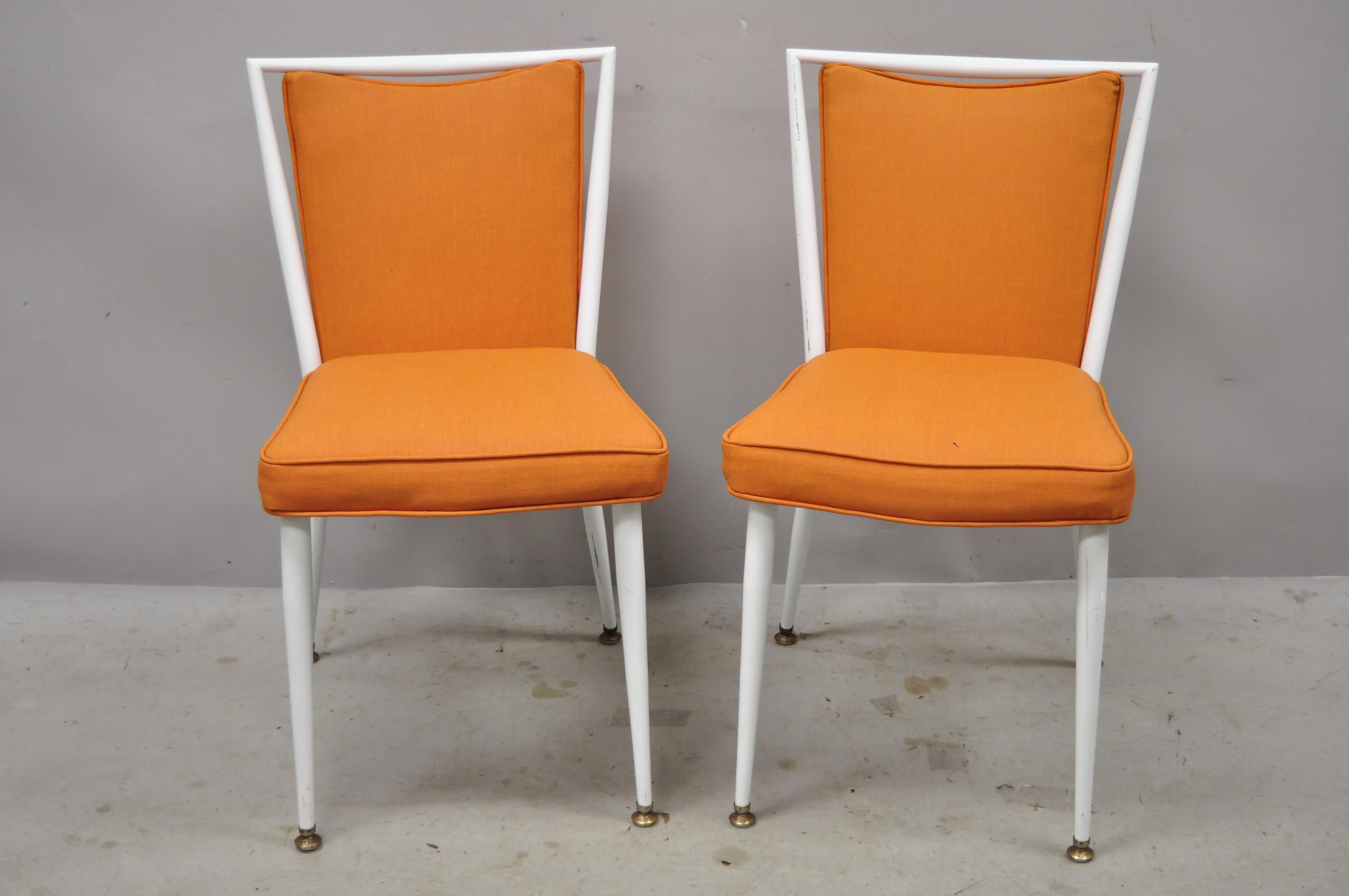 Vintage mid century white enameled steel metal frame orange fabric dining side chairs - a pair. Item features enameled steel metal frame, orange vinyl upholstery, very nice vintage item, quality American craftsmanship, sleek sculptural form, circa
