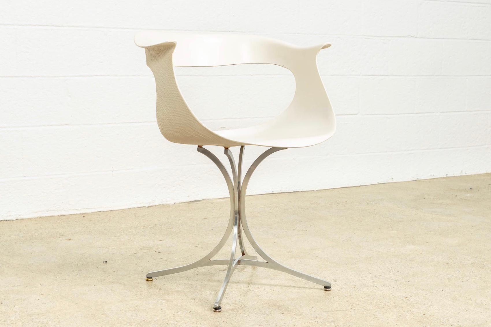 This vintage Mid-Century Modern “Lotus” white on chrome armchair was designed by American husband and wife team Erwine and Estelle Laverne for Laverne International circa 1950. The iconic design features clean lines and elegant curves. The