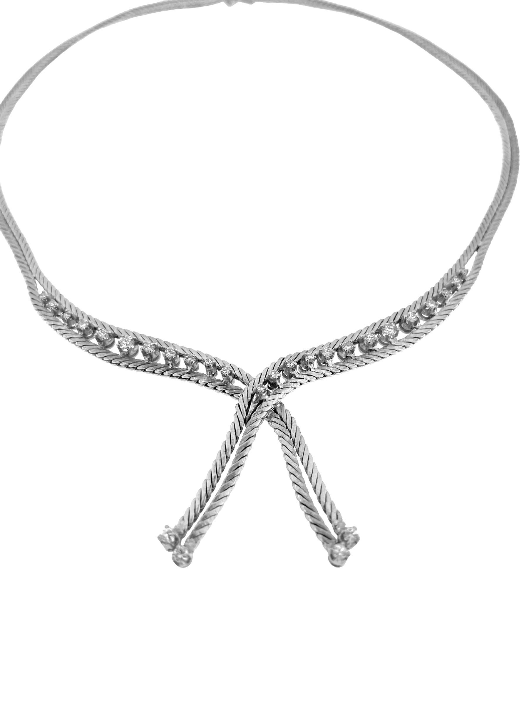 The Mid-Century White Gold Necklace with Diamonds is a timeless piece of jewelry that exudes elegance and sophistication. Crafted from lustrous 18kt white gold, this necklace features a classic design inspired by the iconic herringbone work