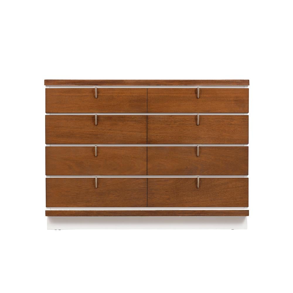 This 1960's mid-century modern chest of drawers has been completely restored, is made out of maple wood, and is newly stained in a walnut & white color combination with a lacquered finish by our team of craftsmen. The dresser features four large