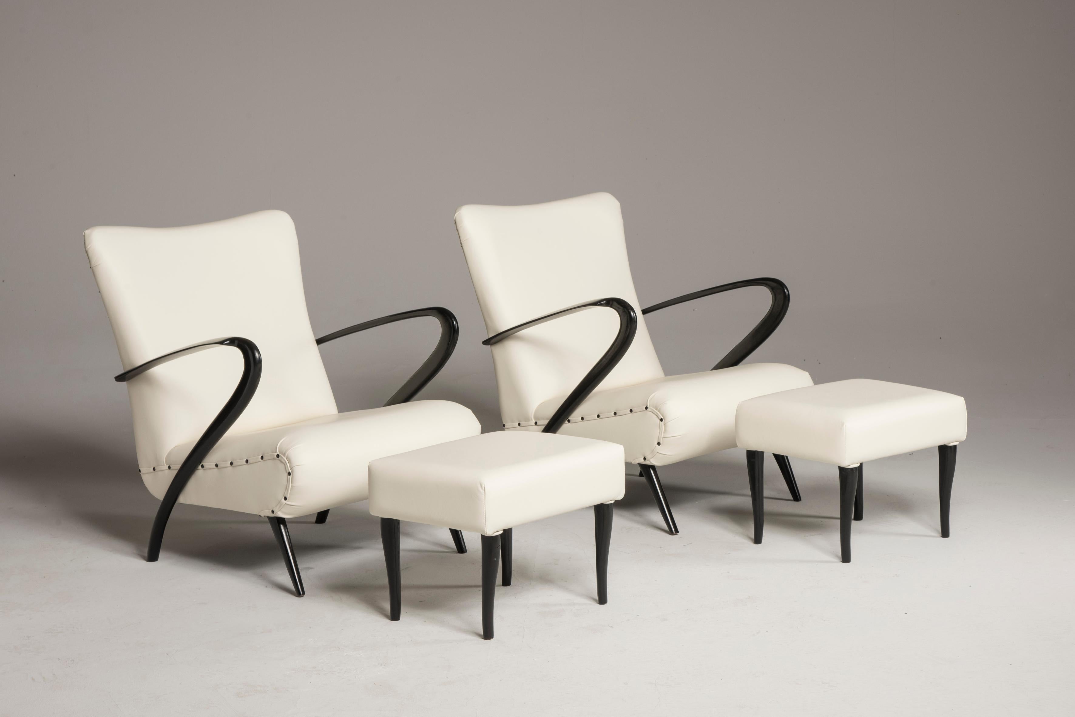 Midcentury white leather black wood armchairs with pouffs.
A pair of armchairs with pouffs from Italy from 1950s period.
They have been reupholstered in premium quality white leather. We have substituted the paddings and restored in conservative