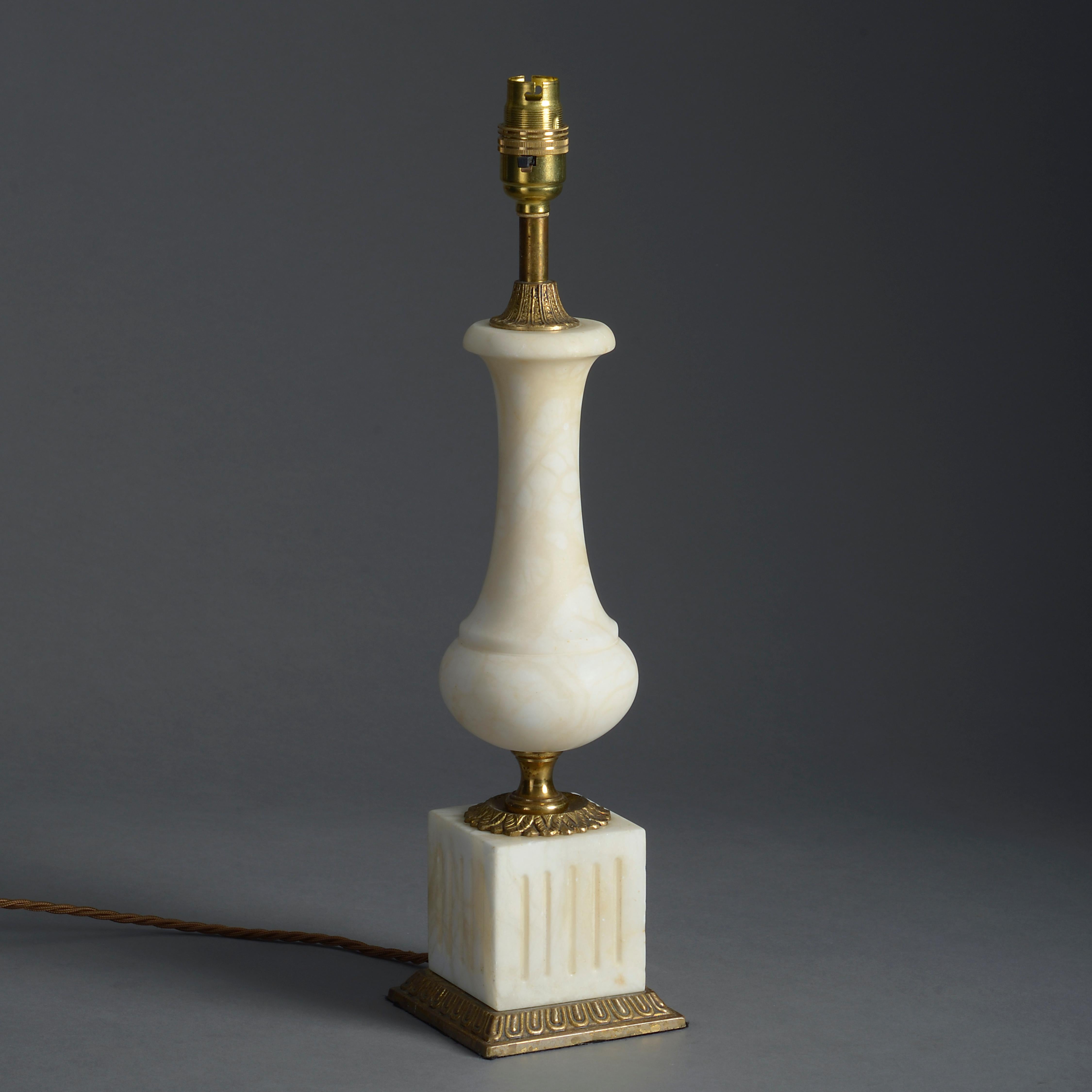A mid-20th century white marble and gilt brass-mounted table lamp in the classical manner.

Height refers to marble and gilt brass elements only.

  