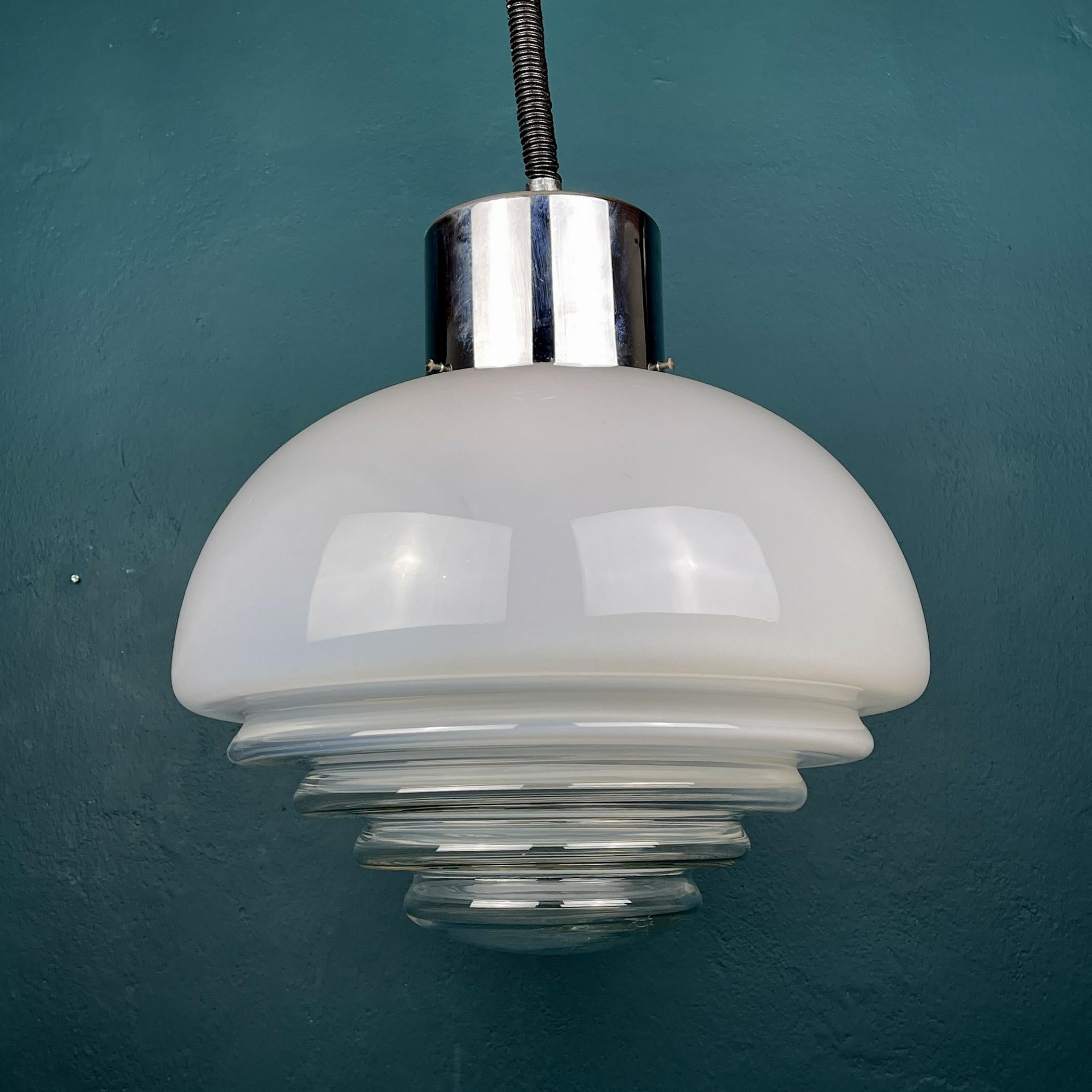 Mid-century milky white Murano glass pendant lamp by Mazzega, made in Italy in the 1970s. The lamp is of a very unusual and rare shape. This perfectly conveys the spirit of the space age, the mid-century style. Excellent vintage condition, no chips