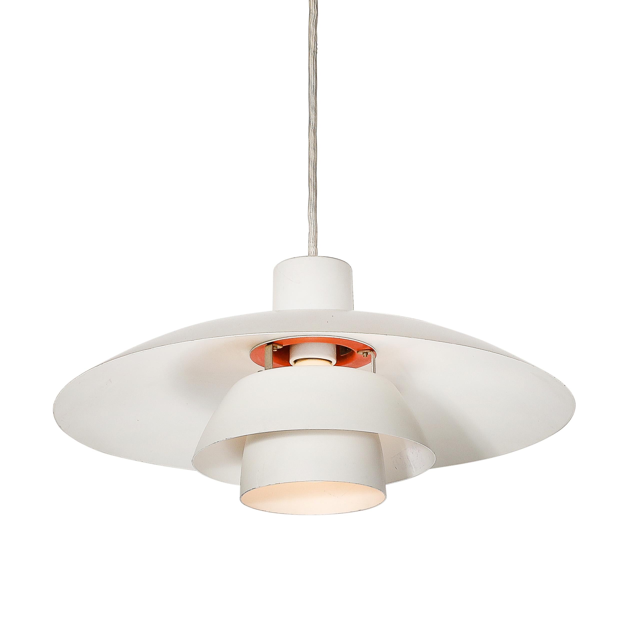 Designed by the renowned Danish lighting manufacturer Louis Poulsen around 1960, this Mid-Century Modernist PH 4/3 pendant chandelier epitomizes Scandinavian design. Its layered shades, finished in white and orange enamel, create a sleek and vibrant