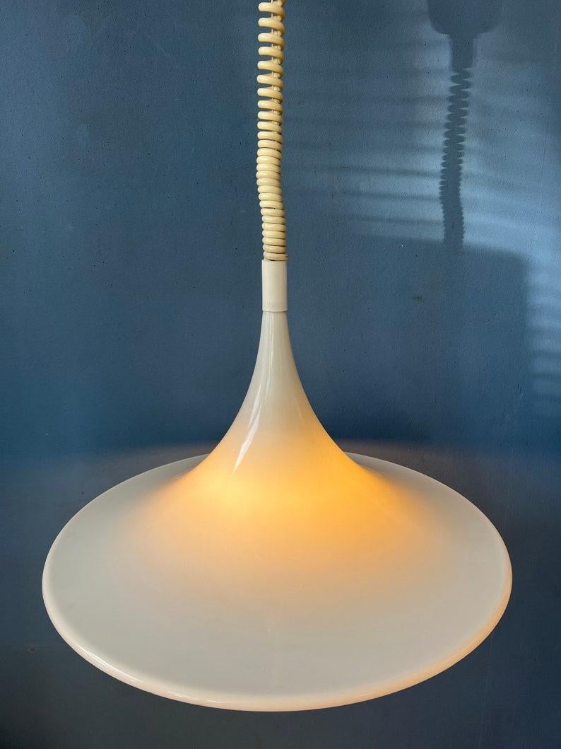 Classic white mid century 'witch hat' space age pendant lamp. The shade is made out of acrylic glass. The lamp produces a warm glow. The height of the lamp can easily be adjusted with the suspension cord. The lamp requires an E27 (E26)
