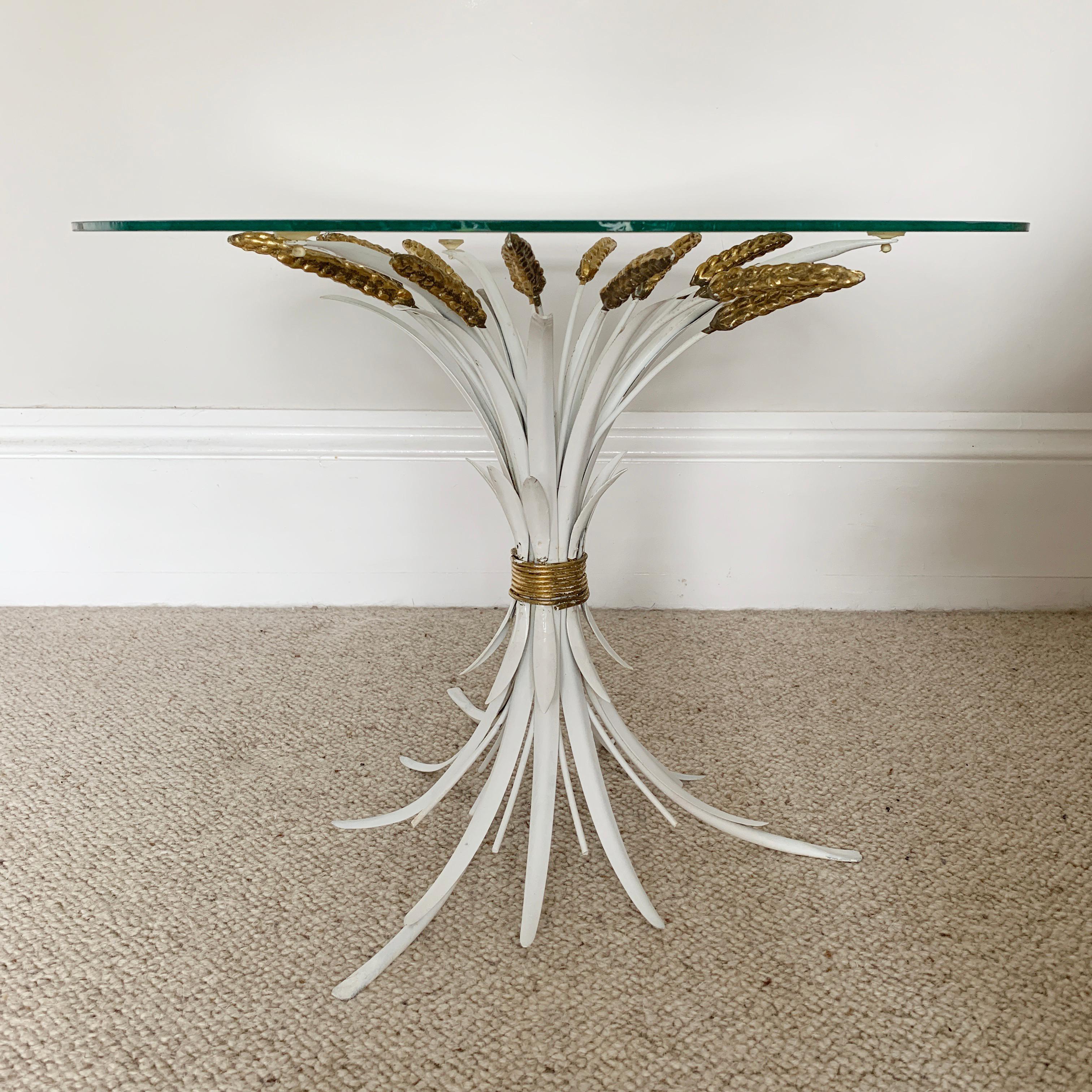 Mid Century wheat sheaf side table
French, 1970s
This is in the rare color combination of white and gold
Measures: 42.5cm height, 55cm width across glass top, 40cm width across feet
The glass top is in good condition.
  