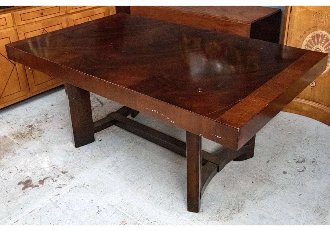 A dining table with fine Modern form in very deep toned and well grained wood. Dating to the 1960’s, the table was made by the iconic furniture maker Widdicomb. In a dark wood with a three book matched plank top, cross banded at each short end.