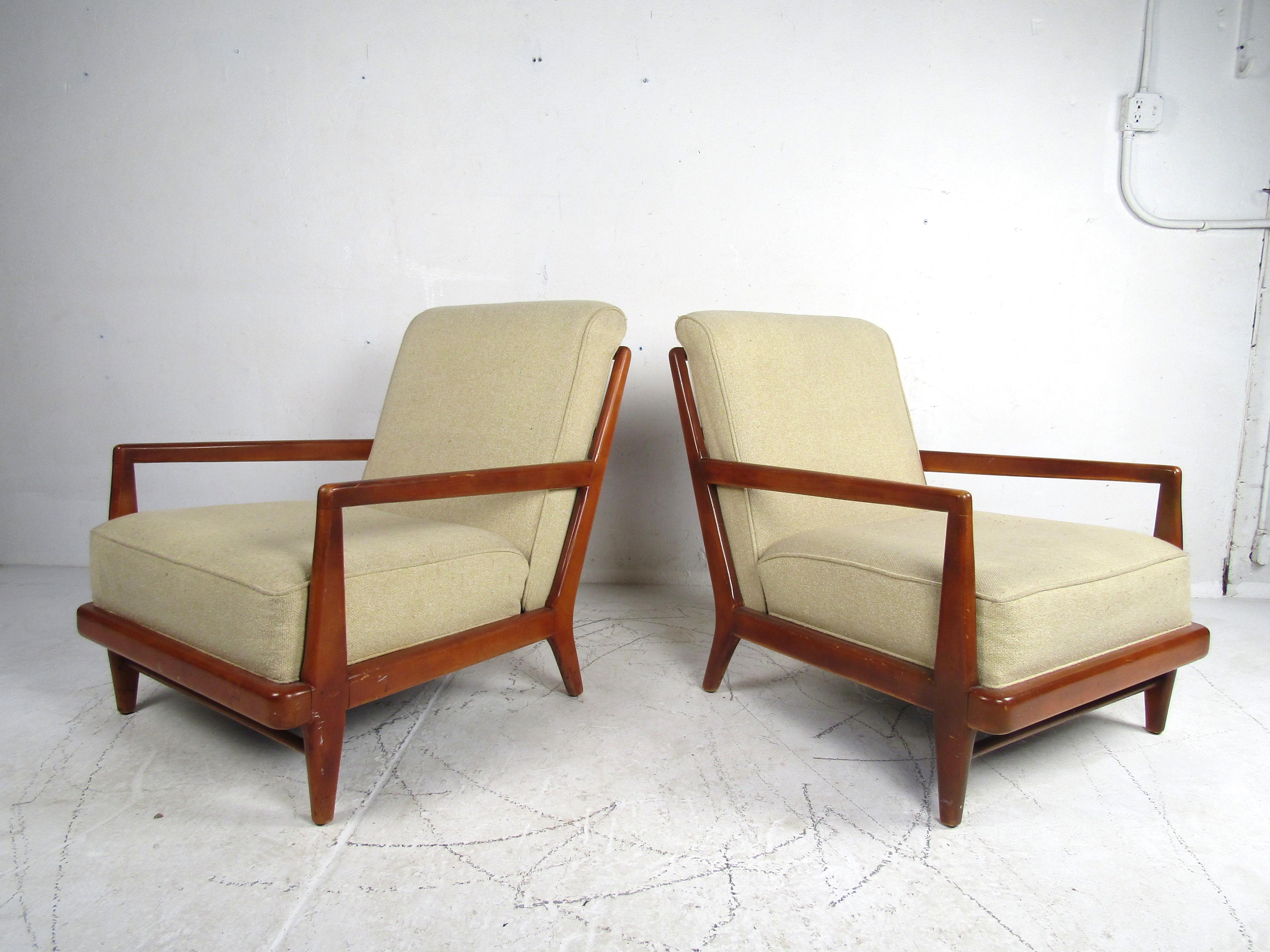 Stylish pair of midcentury Widdicomb lounge chairs. Spacious seating area with large semi-firm cushioning. Handsome angular wooden frames. A great addition to any modern interior's seating arrangement. Please confirm item location with dealer (NJ or