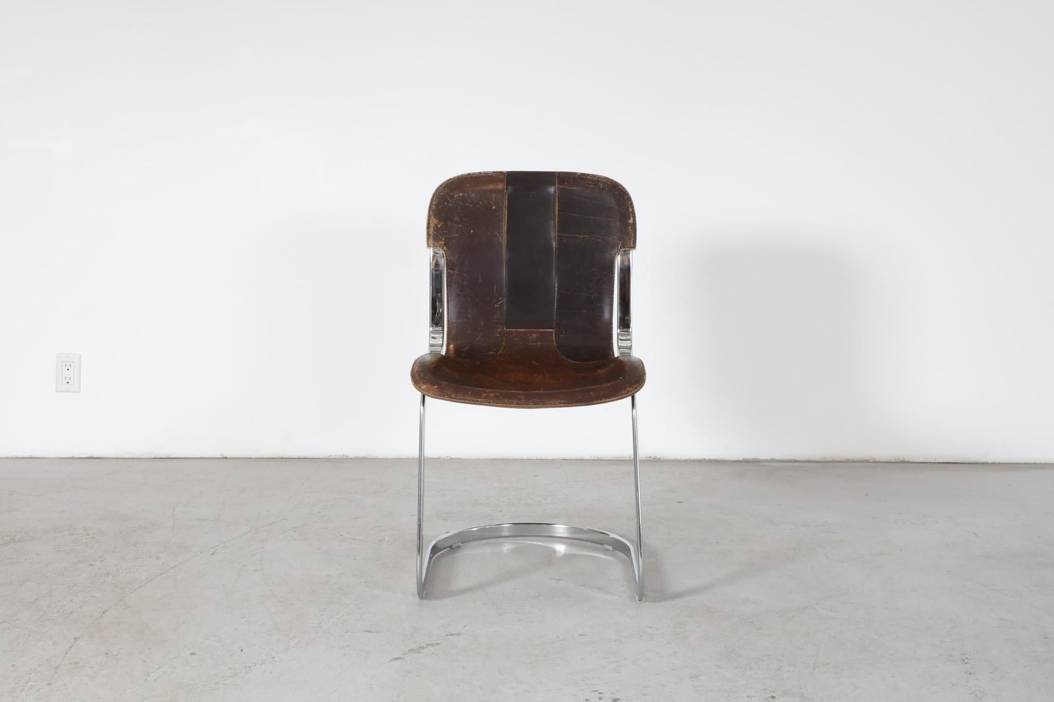 Mid-Century steel and leather chair by designer Willy Rizzo for Italian design house Cidue. In original condition with visible wear and heavy patina, consistent with its age and use. Original foot inserts were replaced with felt pads. Matching set