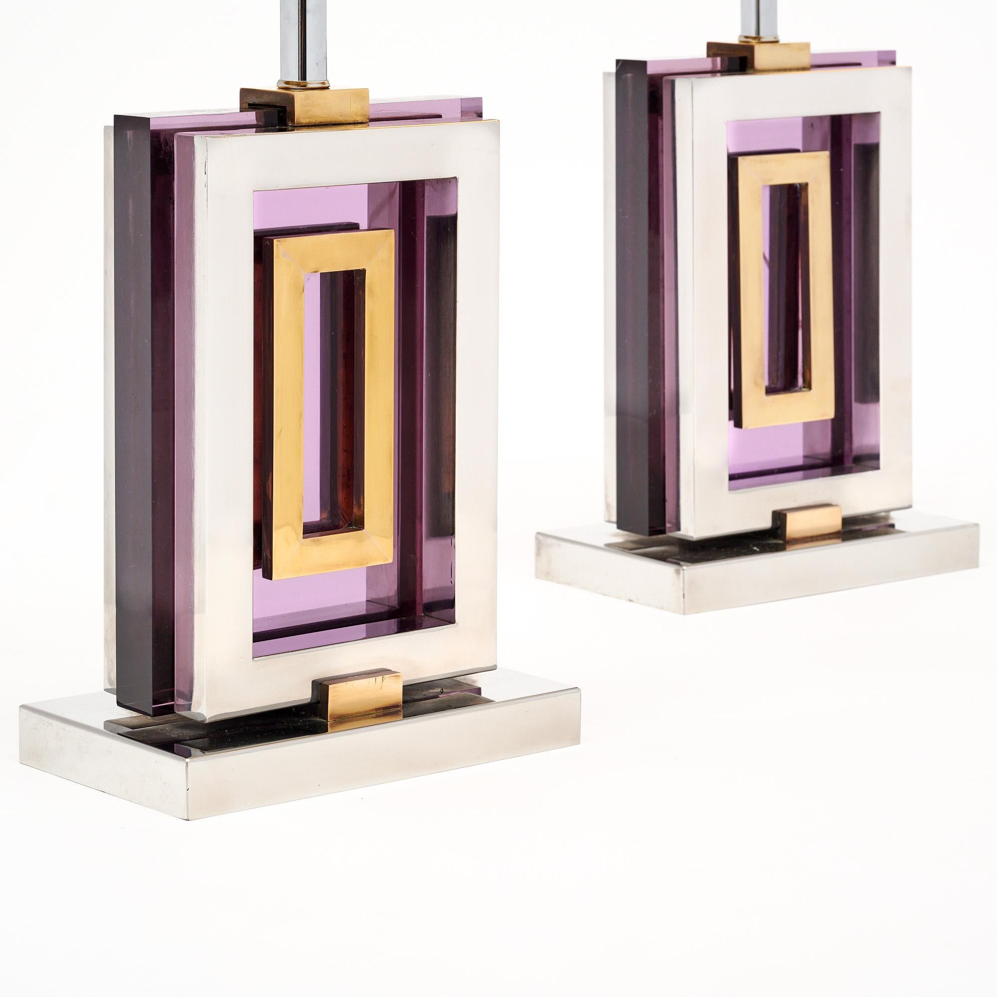Pair of lamps from mid-century Italy in the style of renowned designer and photographer Willy Rizzo. This pair has a chrome structure with brass detailing and a purple Lucite center. They feature a silver shade custom crafted for the pair. They are
