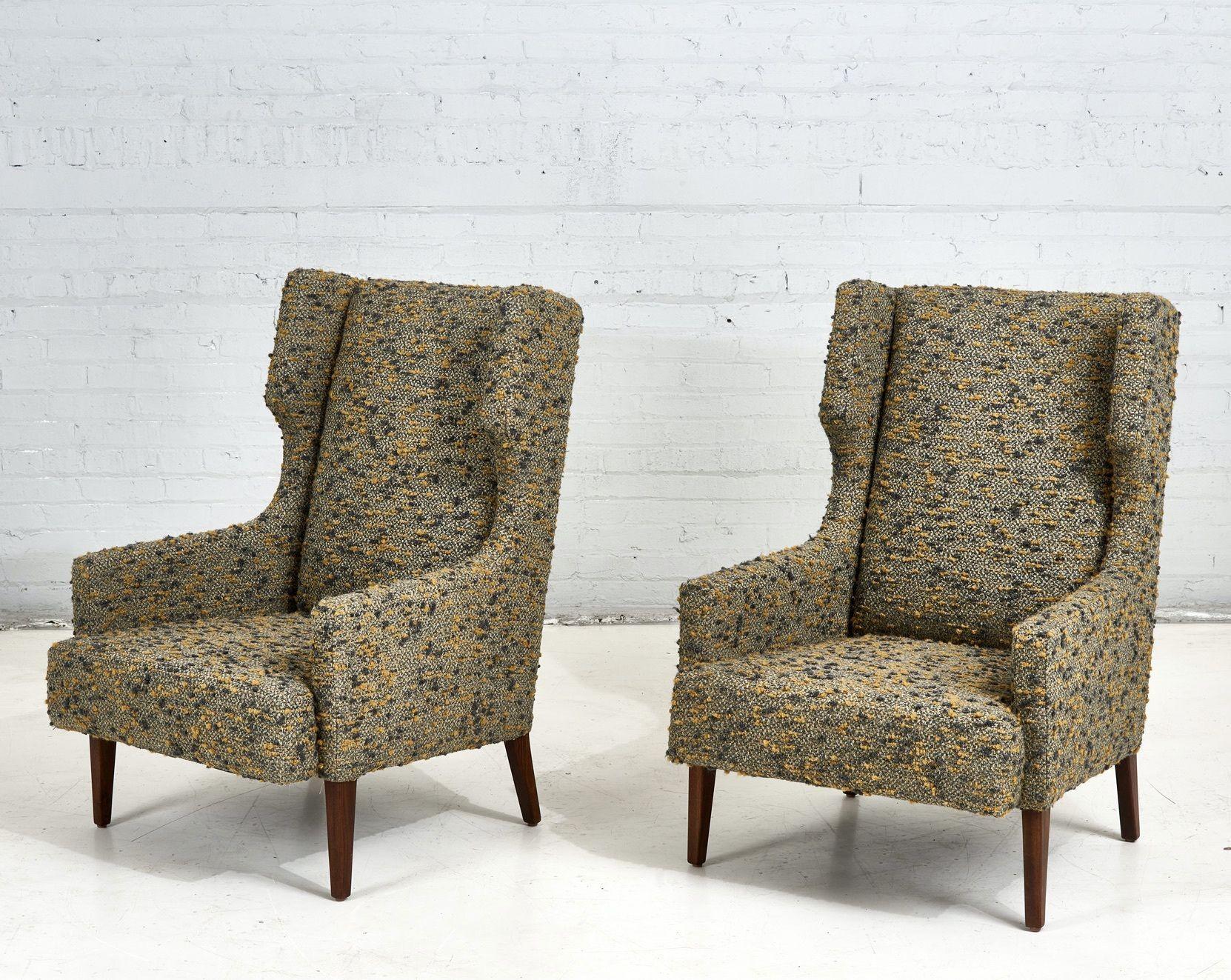 Pair of high back wing lounge chairs in the style of Dunbar, 1960. Fully restored. Newly reupholstered in textured nubby boucle with refinished walnut legs. Similar to Edward Wormley designs for Dunbar of the same era.