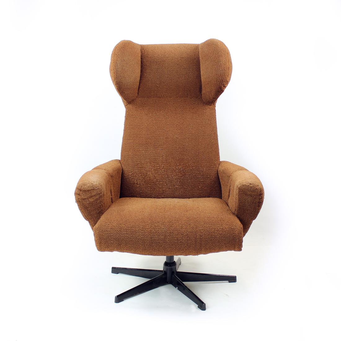 Beautiful wing chair produced in Czechoslovakia in 1960s. Amazing, elegant design and functionality make this chair a stand out in any interiors. The chair swivels on a strong metal leg and has a black metal base. Can be used as it is, however, the
