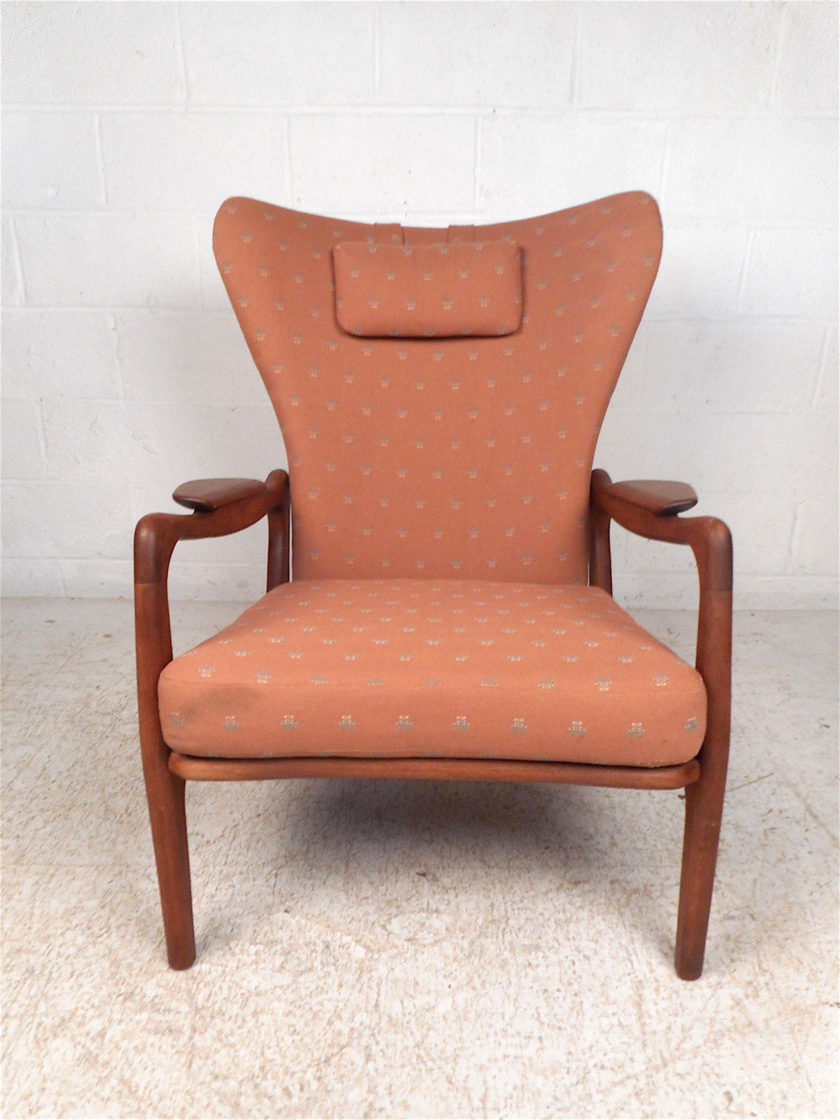 Impressive wingback chair designed by Adrian Pearsall. Tall backrests and deep seating covered in vintage salmon-colored upholstery. Sturdy walnut frame with sculpted armrests, circa 1960s. A stylish and comfy addition to any modern interior. Please