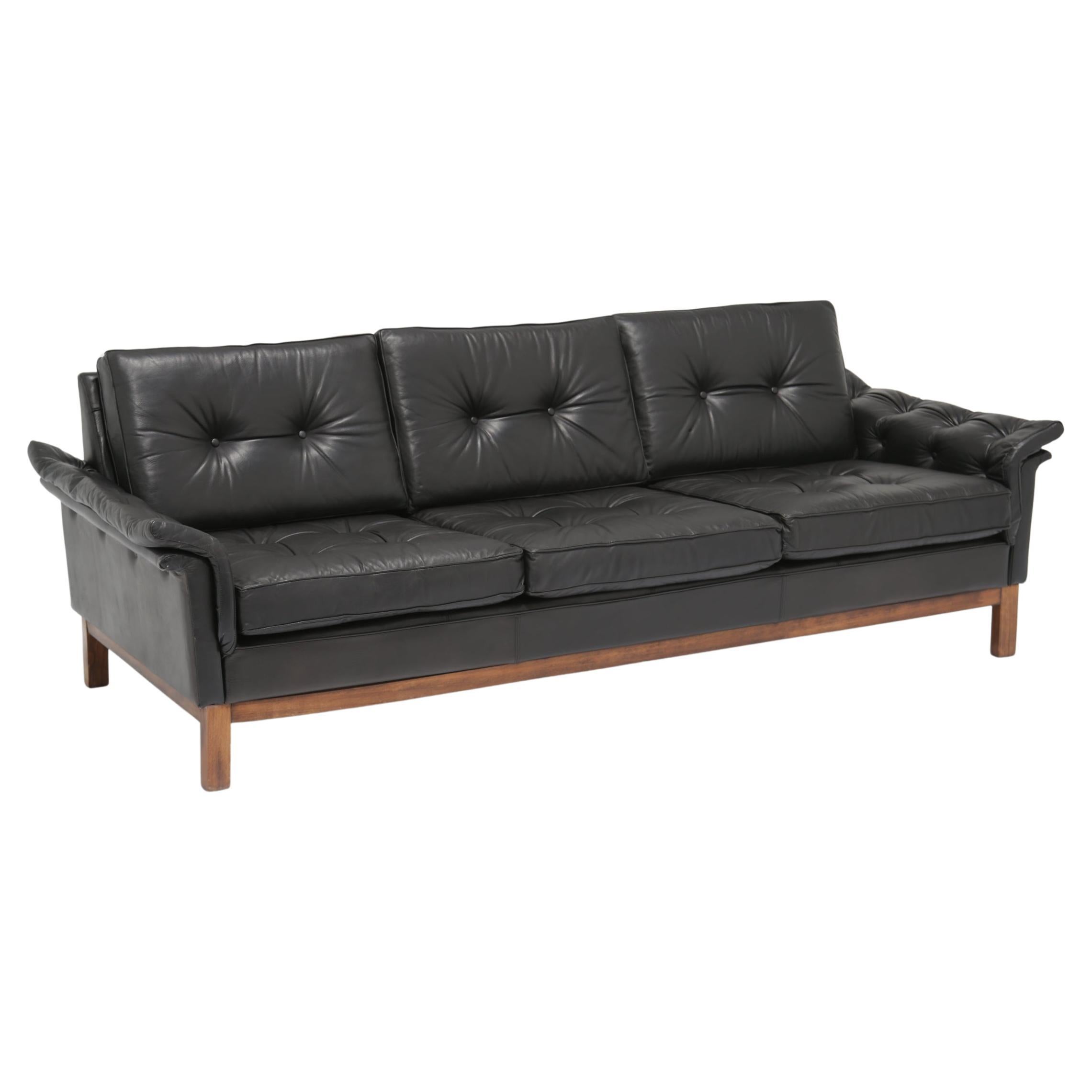 Mid-Century Winged Black Leather 'Kardinal' Buttoned Three Seat Sofa, 1960s.