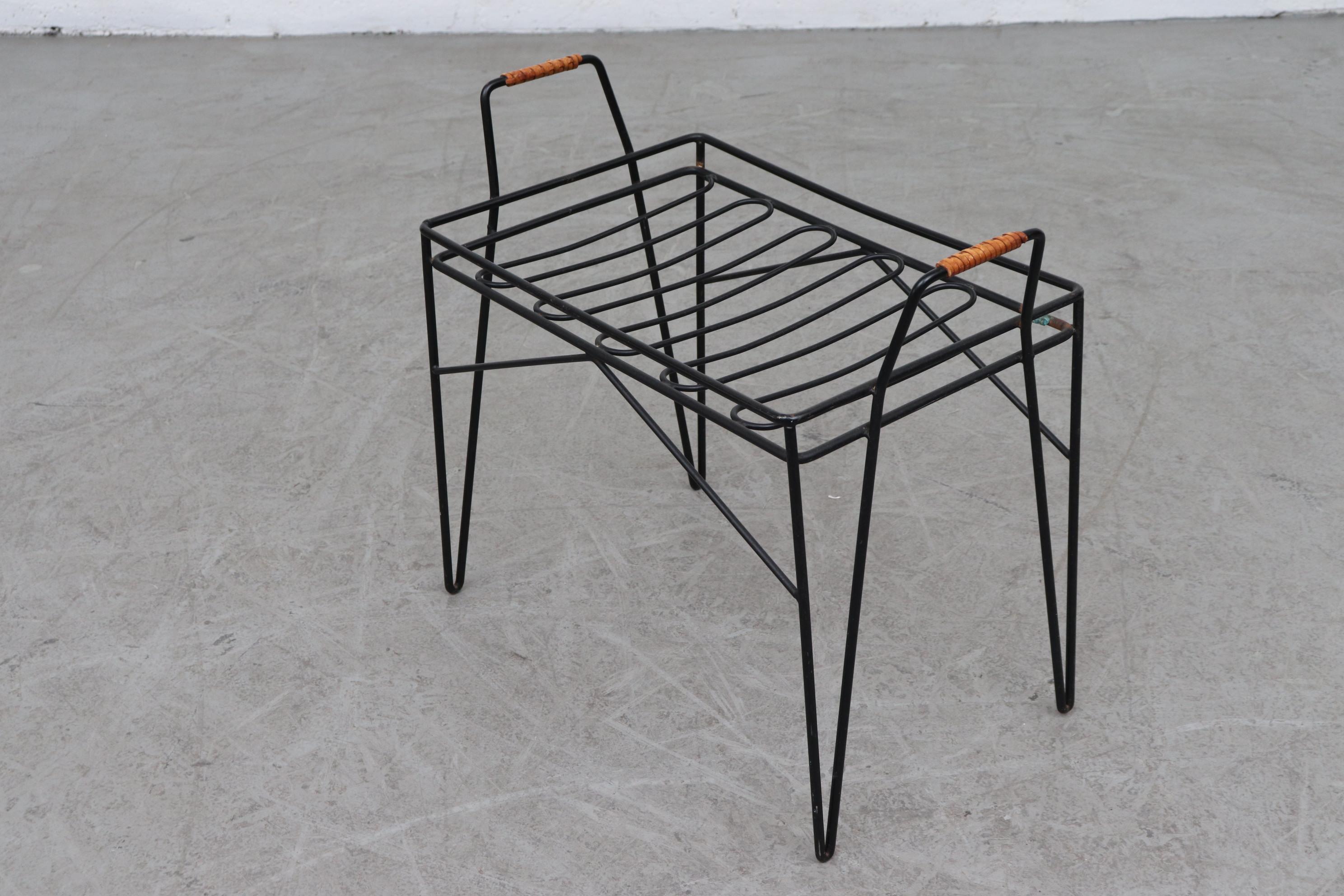Sweet midcentury black enameled metal wire framed stool with new natural canvas seating and leather wrapped handles. Metal in original condition with visible wear. Leather has nice patina.