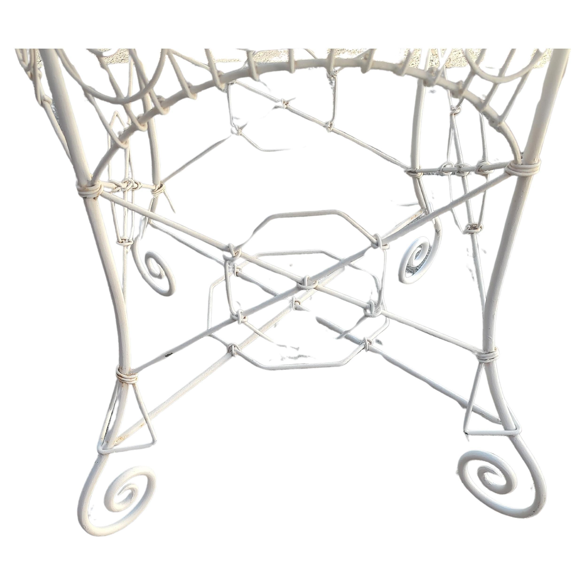 Fantastic iron wire garden & patio dining table with a half inch thick glass top. With the glass top table is 36 diameter by 30 high. Fantastic iron wire design with a rolled edge and fancy scroll work. Evoking the Victorian era with a touch of the