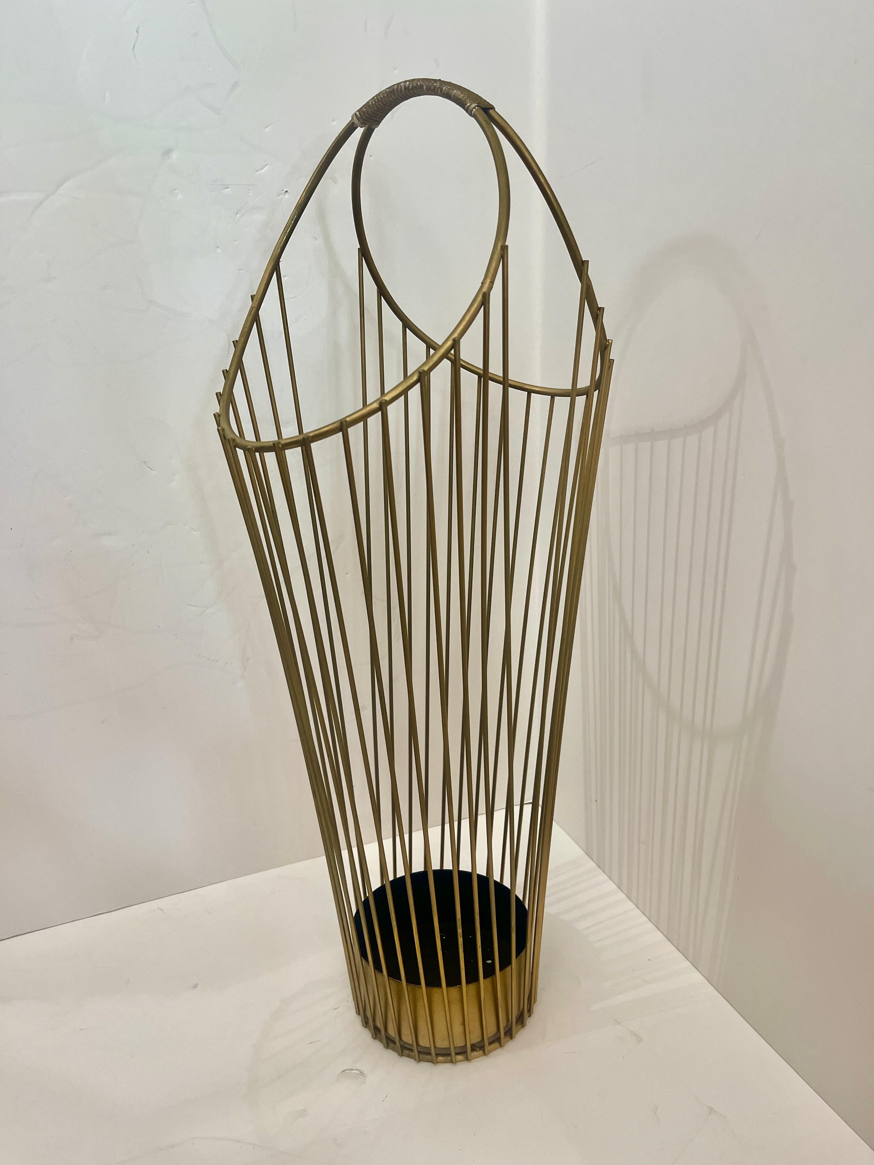 This is a French Mid-Century Wire Umbrella Stand In The style of Mathieu Mategot.
Made with metal wires and a large convenient handle, and has two sides to contain umbrellas and waling sticks.
The insert is original to the item, usually it is lost