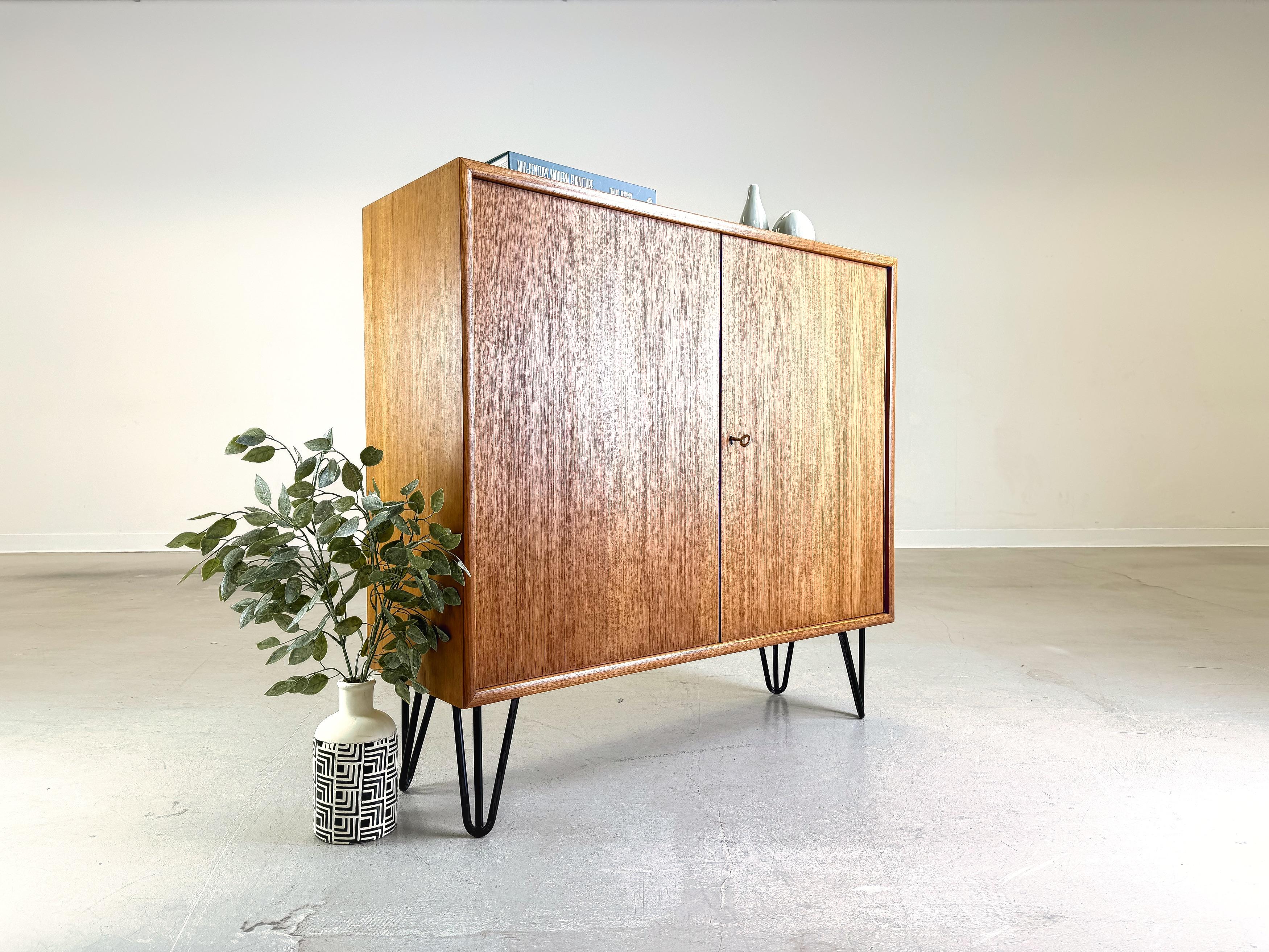 We are offering a beautiful teak chest of drawers from WK Möbel for sale. The module comes from a wall unit and has been professionally refurbished by us and fitted with hairpin feet. Made from high-quality teak, this piece combines Scandinavian
