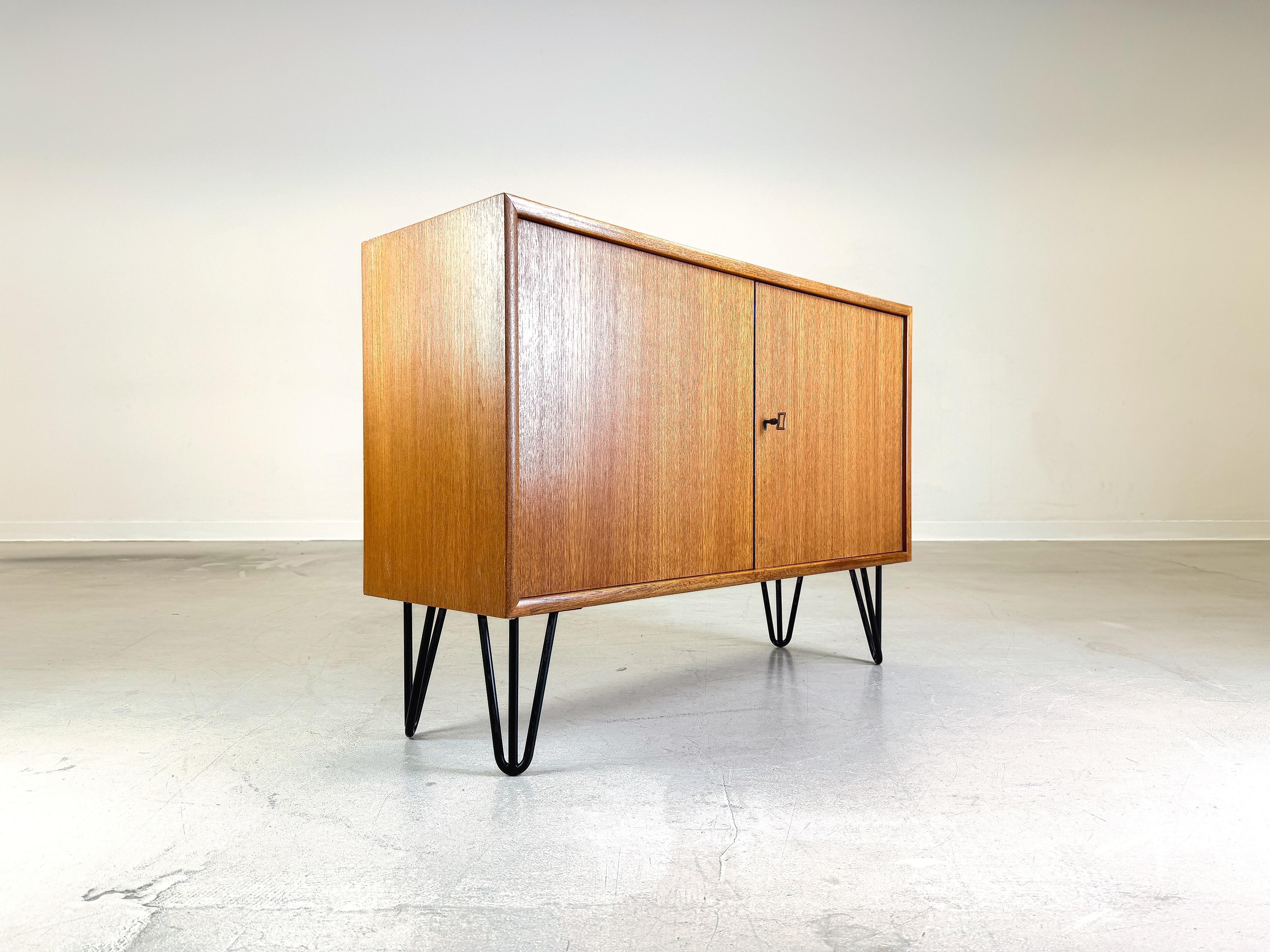 We are offering a beautiful small teak chest of drawers/ sideboard from WK Möbel for sale. The module comes from a wall unit and has been professionally refurbished by us and fitted with hairpin feet. Made from high-quality teak, this piece combines