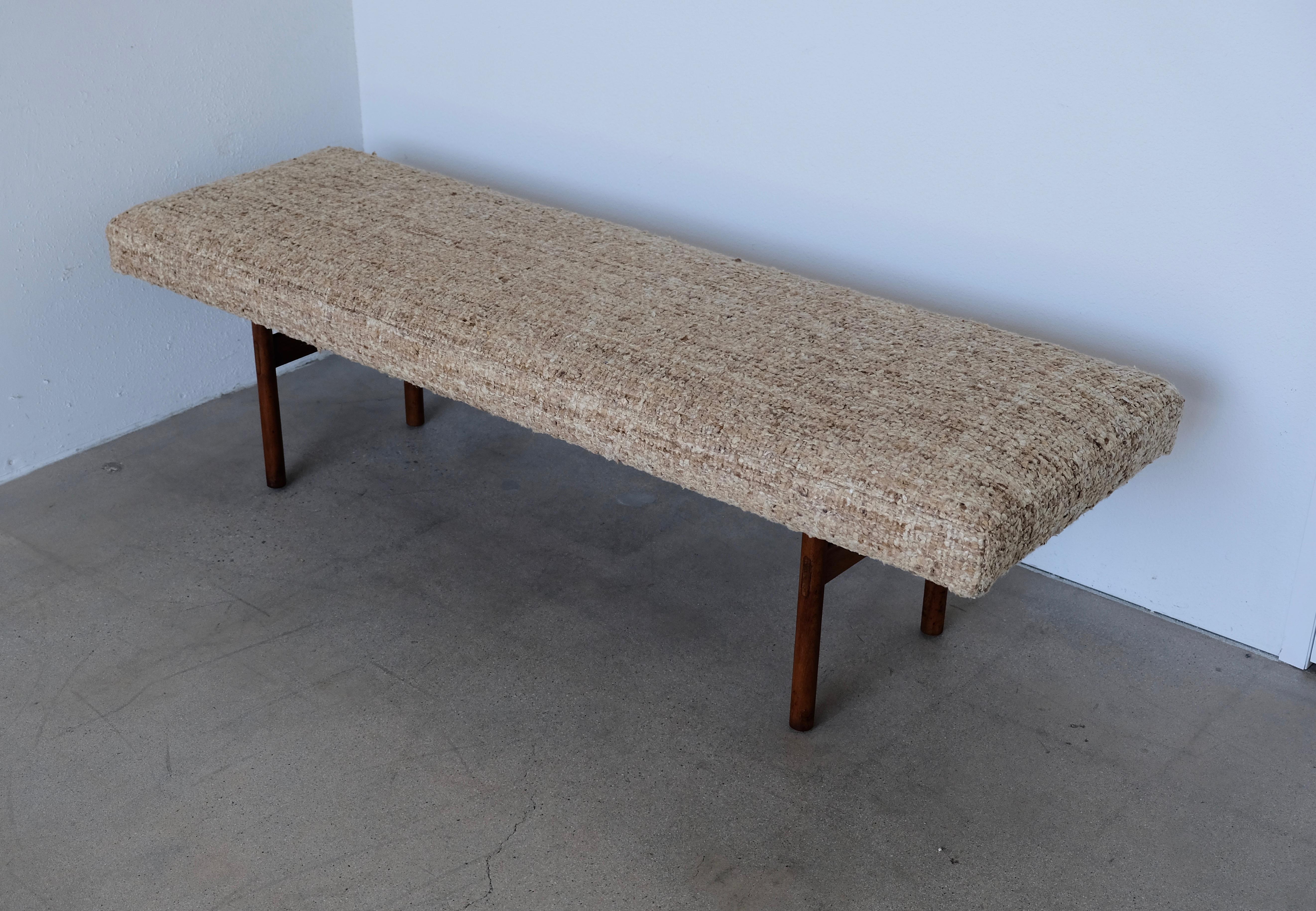 This vintage wood and aluminum metal bench is well made with joinery construction. The aluminum strut underneath the bench gives the vintage modern midcentury strength and style. The bench has been redone with new foam and a natural nubby textural