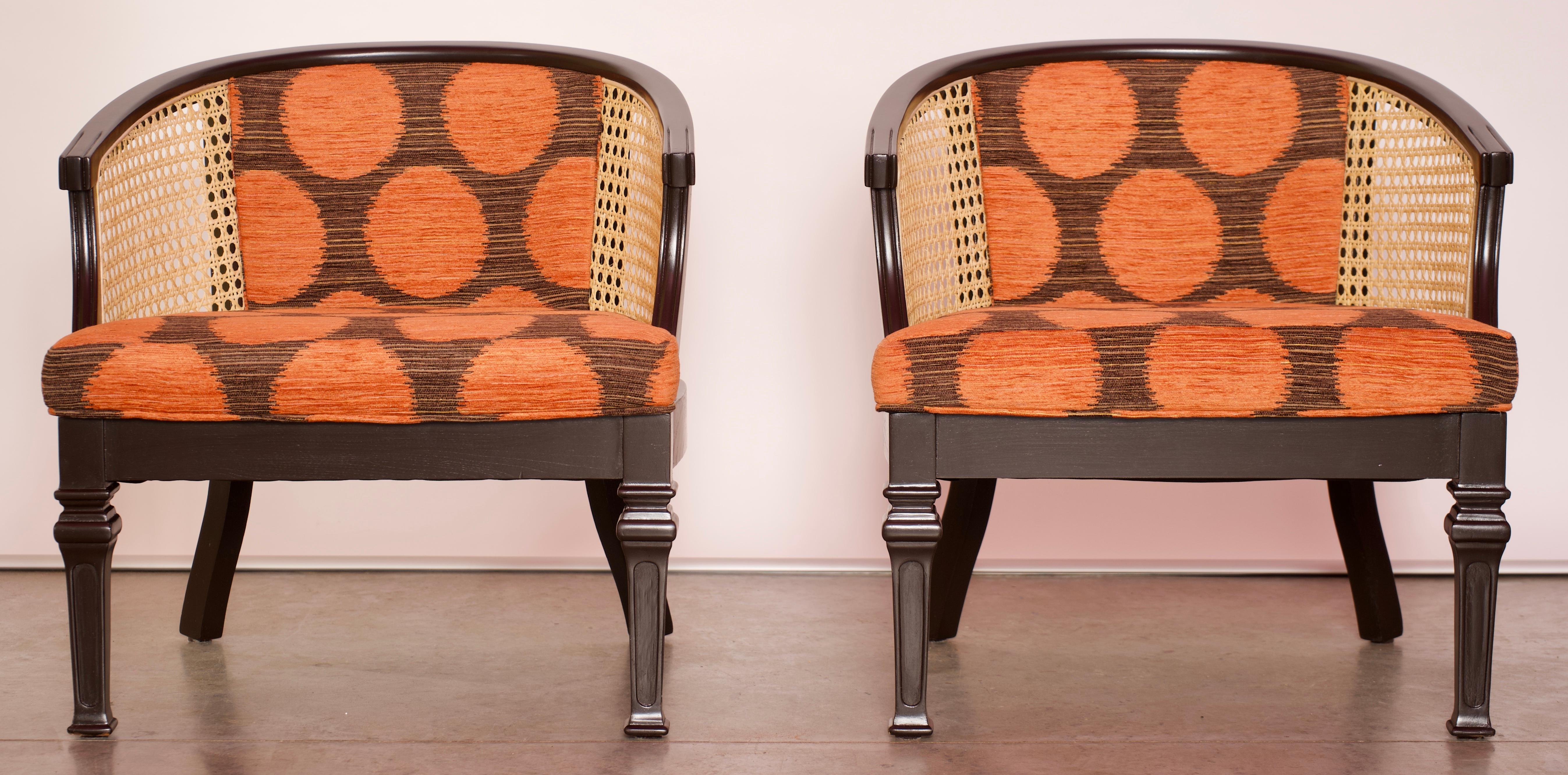 Set of two midcentury wood and cane barrel chairs that have been fully refurbished with a high-quality orange and brown polka-dot fabric. The legs and wood have been painted with a high quality lacquer to protect the original woodwork of the pieces.