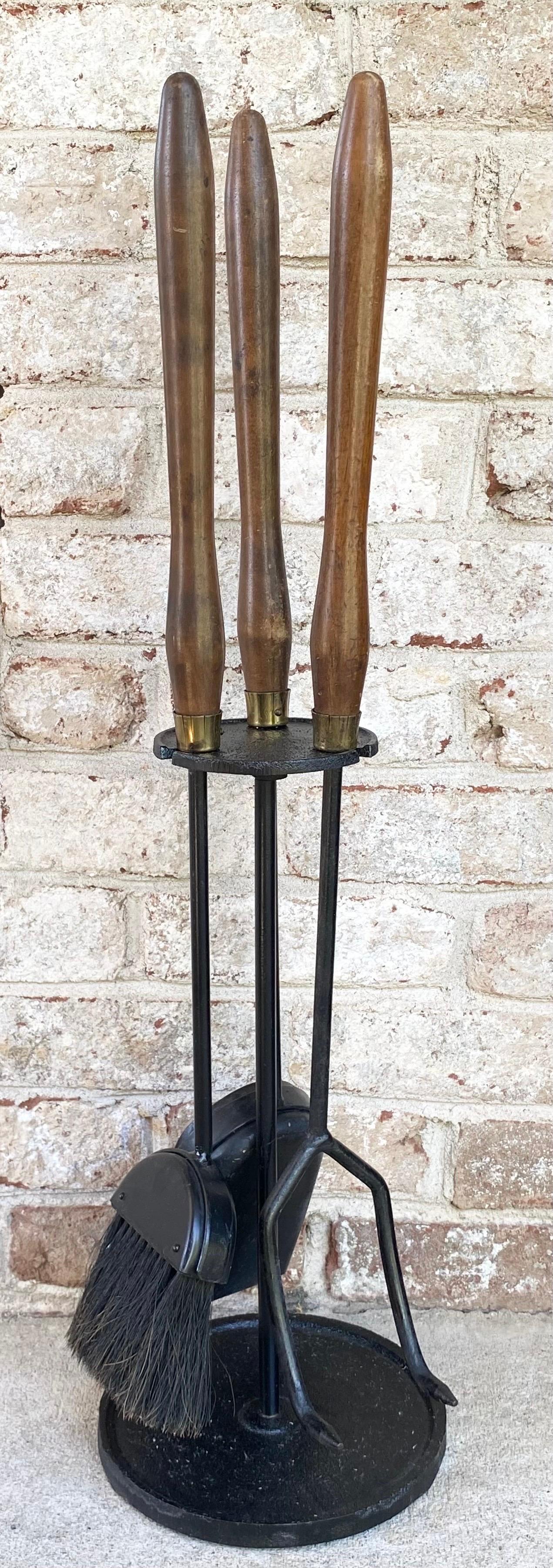 Modernist mid-century set of fireplace tools with wood handles.

The measurements of the stand are 18.5