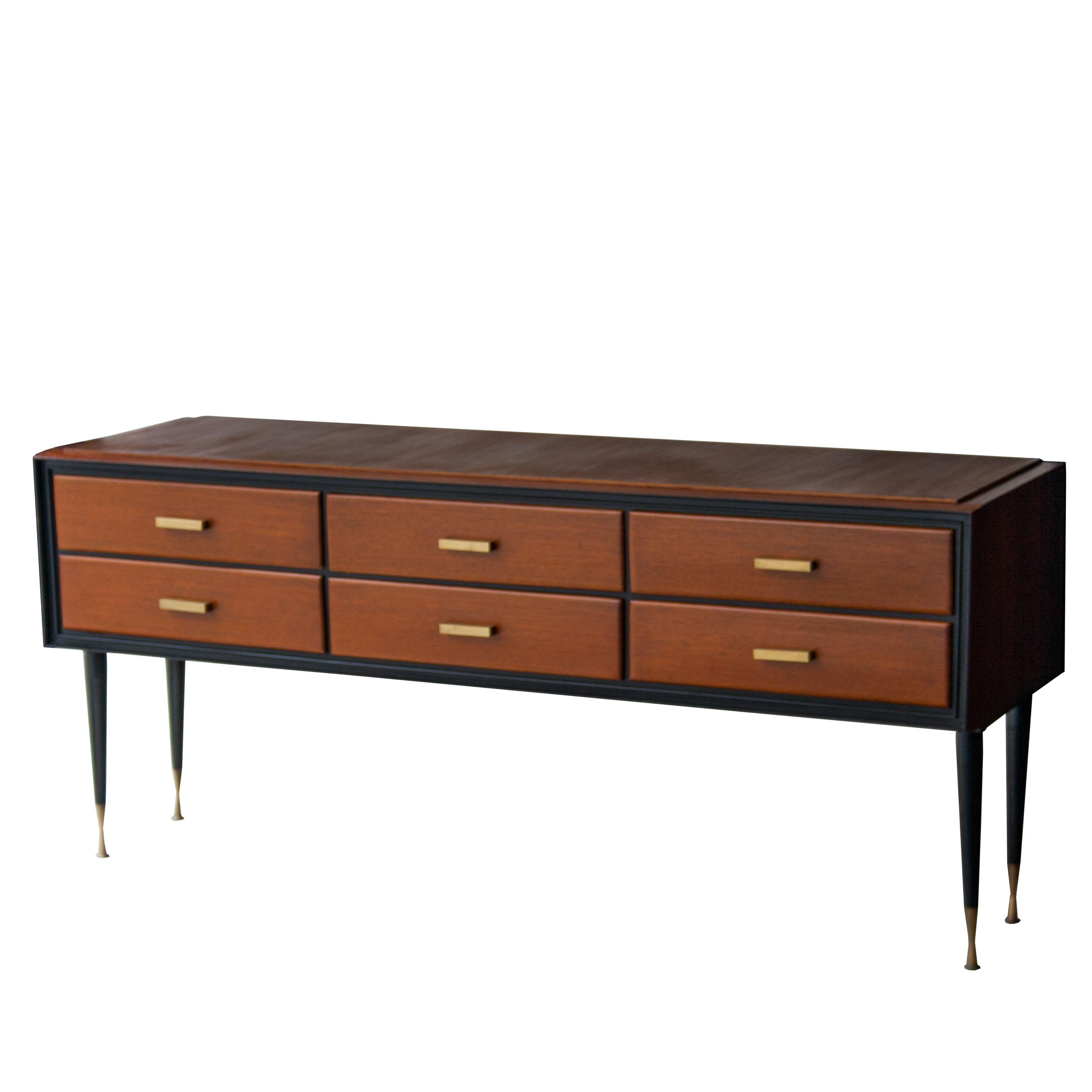 Midcentury Italian sideboard with six drawers. Made in solid wood, with black lacquered legs and details. Pulls and legs finished in brass details.
 