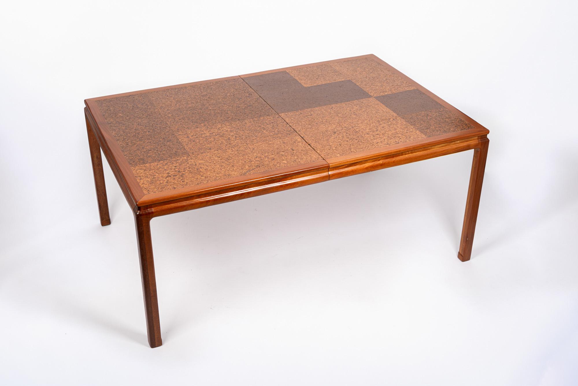 This vintage mid century modern dining table was designed by Edward Wormley for Dunbar circa 1960. This exceptional table has clean, minimalist lines and is expertly crafted from mahogany wood and cork with a patchwork pattern cork tabletop and
