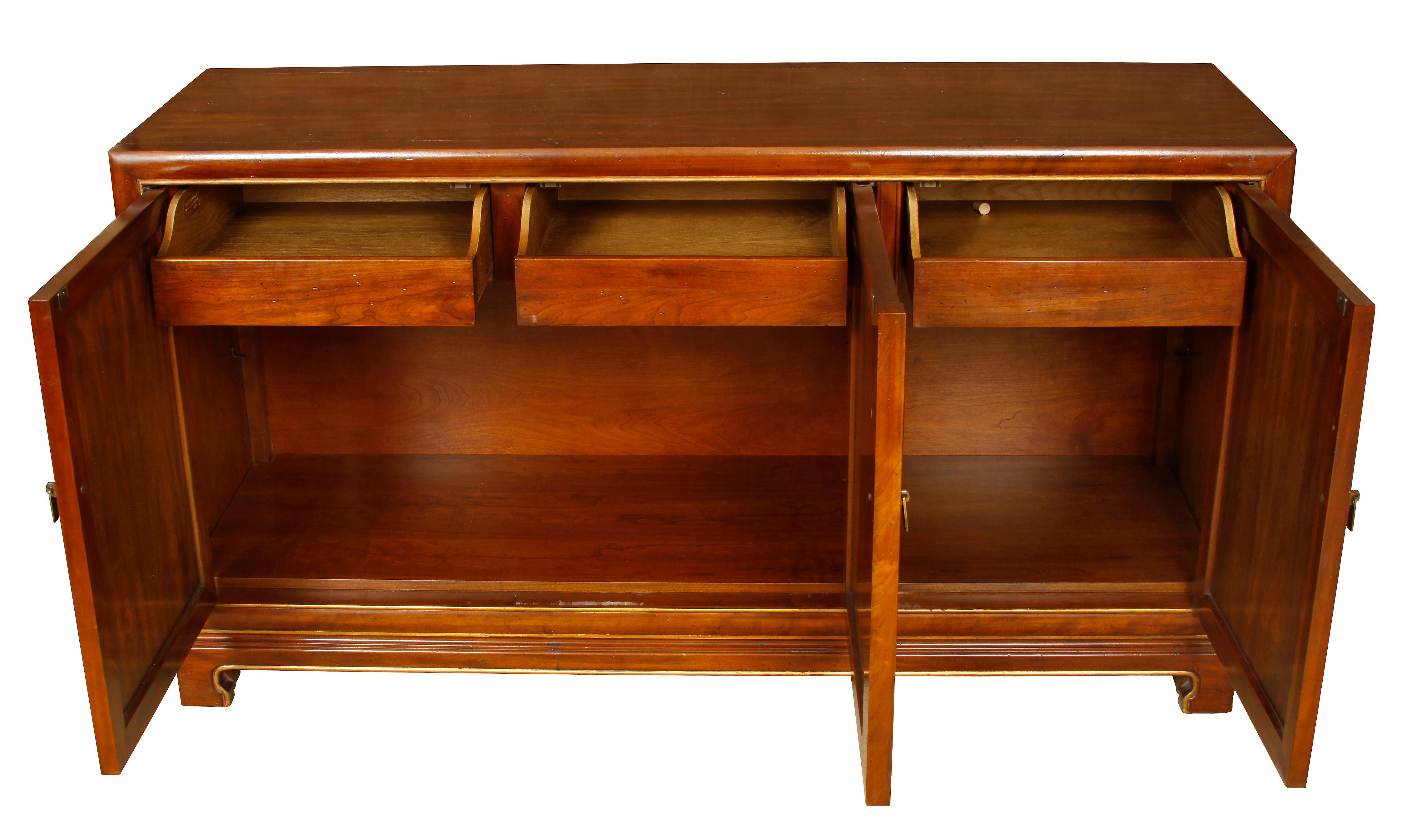 Mid-Century wood credenza with Gilt detail. Three drawers and ample storage interior