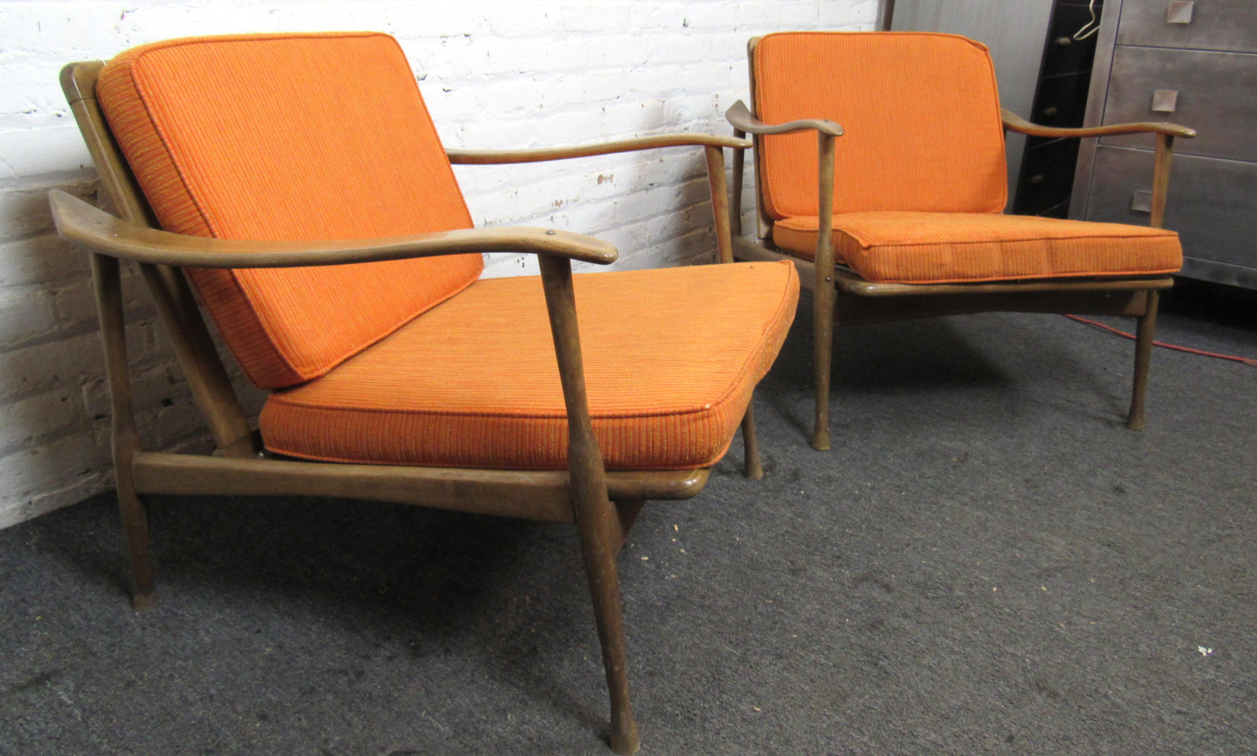 Pair of mid-century modern chairs with sculpted arm rests. Two simple cushions that can easily be recovered. Attractive slat back for mid room placement.

Please confirm location NY or NJ.