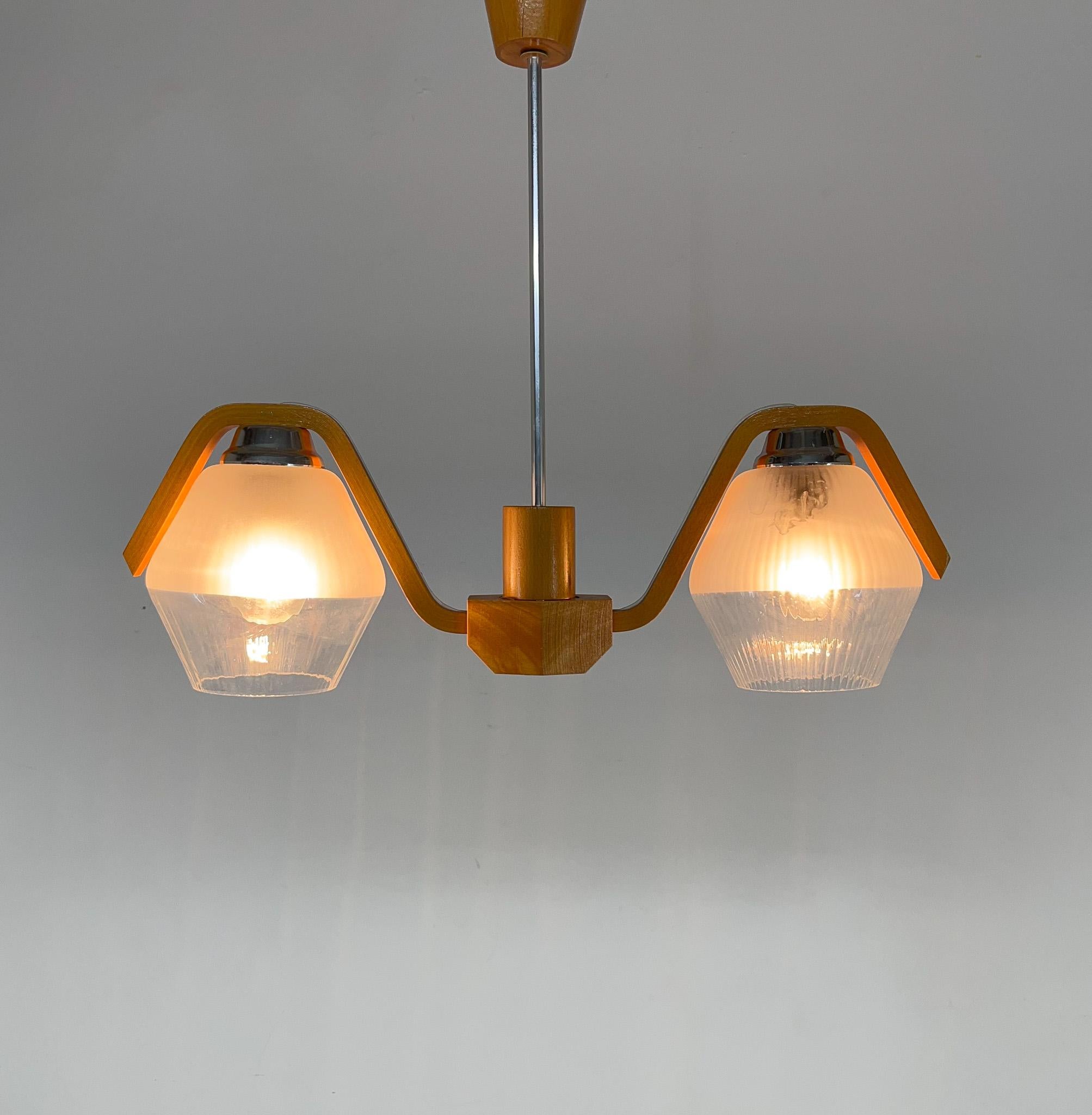 Wood and glass 2-arm chandelier made by Drevo Humpolec in former Czechoslovakia in the 1960's. Bulbs: 2 x E25-E27.