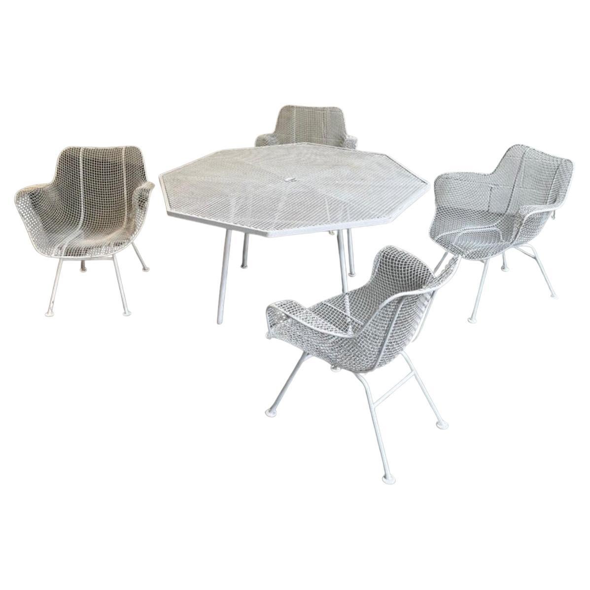 Mid Century Vinatge Woodard Sculptura Iron Garden Patio Table and 4 Chair set. Great set in good vintage condition has been painted white a few times all chairs and table are structurally sound. Ready for use in your back yard or patio. 

Local pick