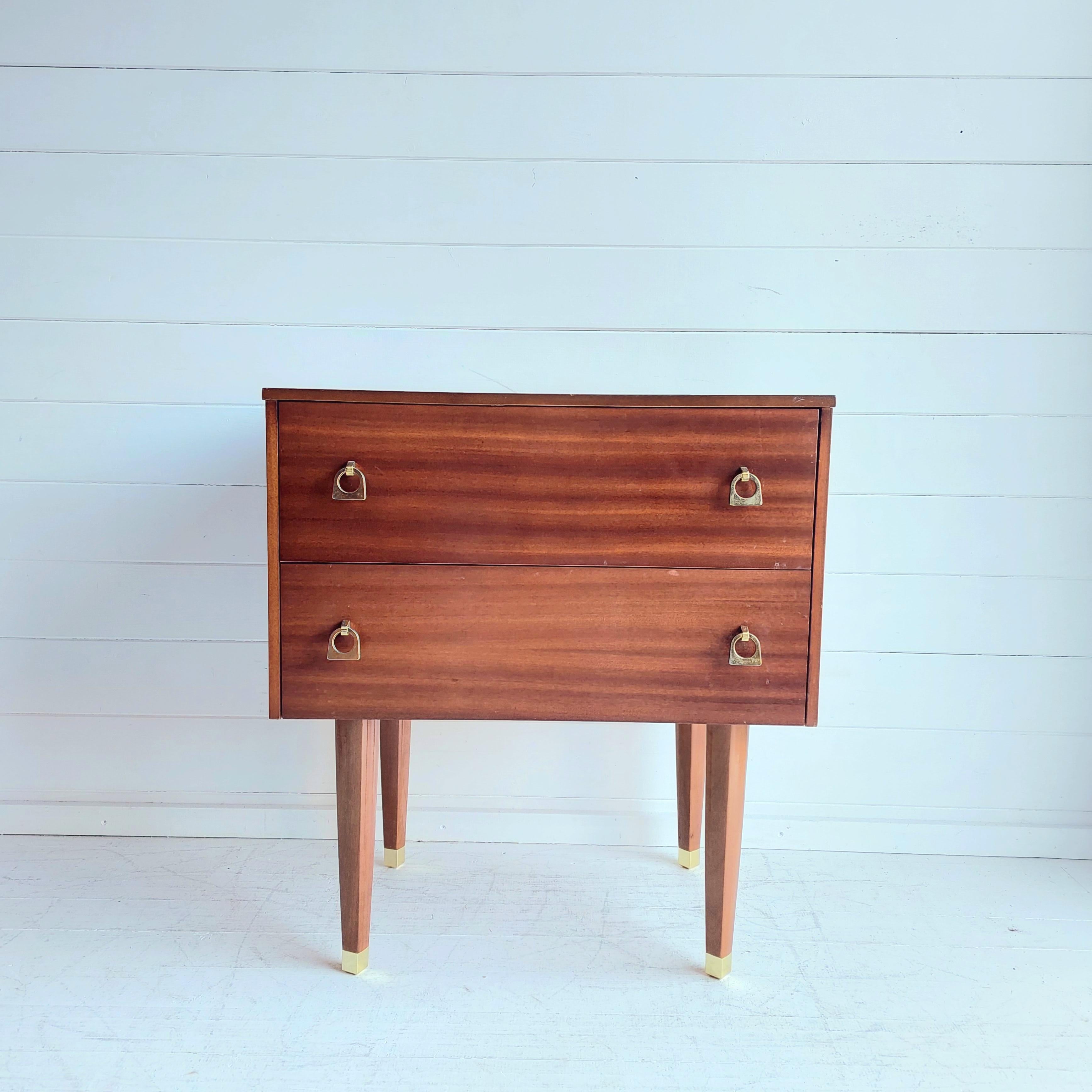 Minimalistic nightstand from the 60s era.
Original mid-century bedside table . 
This is made from a lovely wooden veneer with lovely grain and rich colour and with 2 fitted drawers. 
The drawers have dovetail construction. 
Vintage mid-century