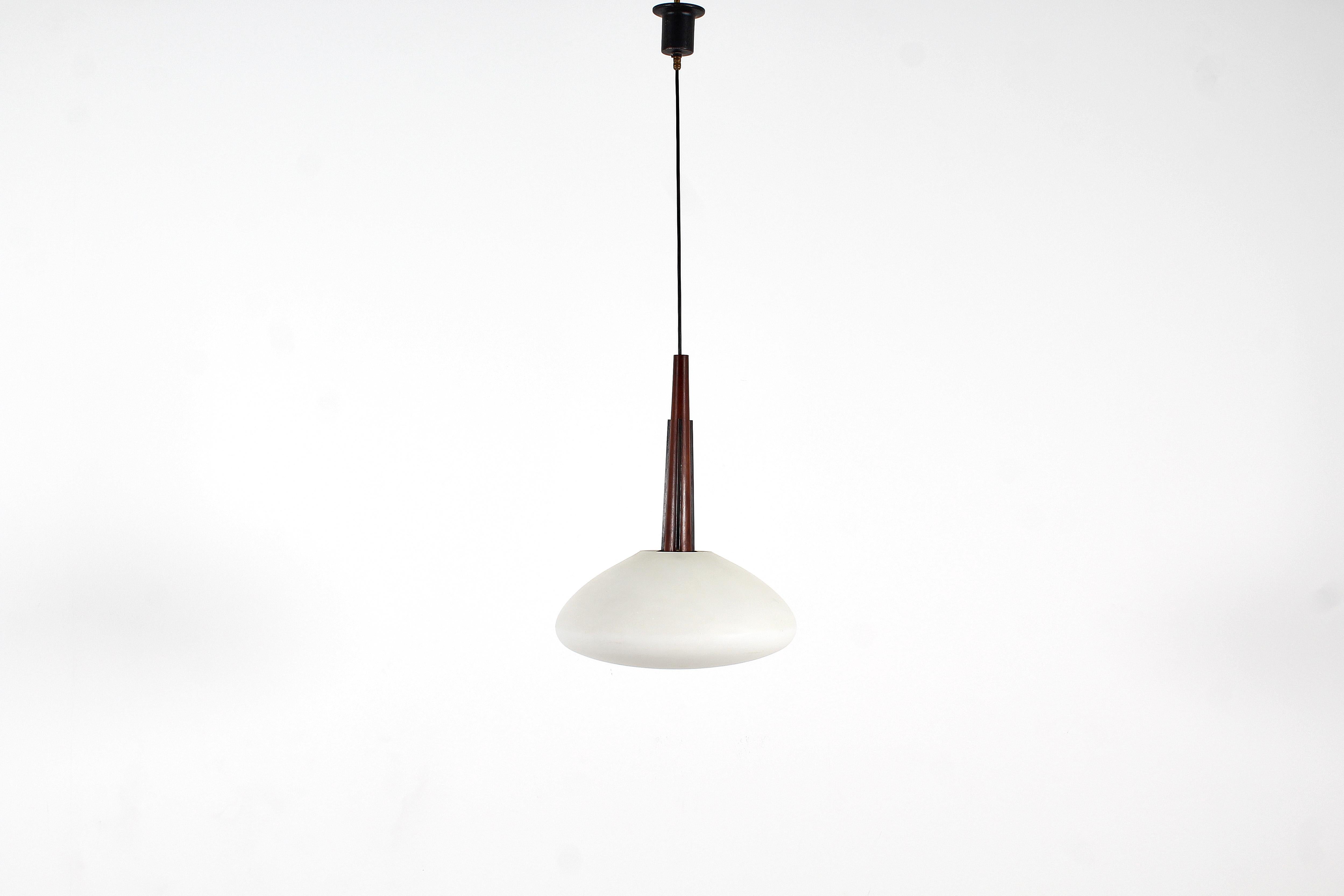 Very beautiful wooden suspension lamp with circular frosted glass globe, Italian production from the 1960s.
Where consistent with age and use.