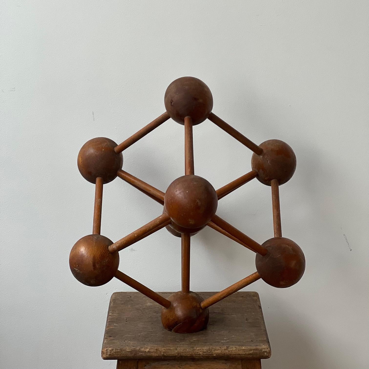 A wooden geometric model believed to be an homage to the Brussels Atomium building. 

Belgium, c1960s. 

Ideal as a desktop display or shelf curio.

Unusually created out of wood and much larger than the usual smaller metal or plastic models.