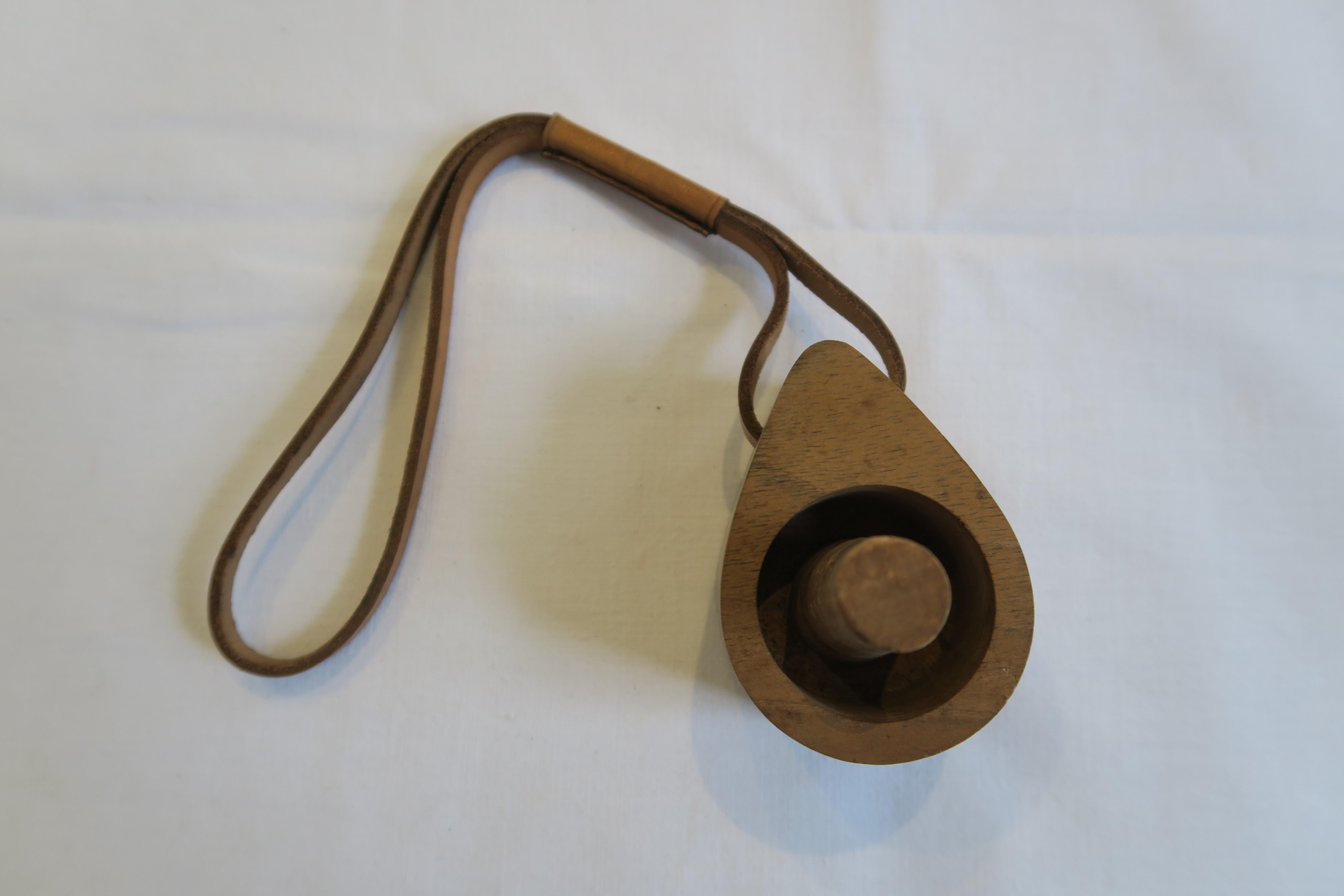 The item on sale is an original Carl Auböck bottle stopper. It was hand crafted and is made from the finest wood and cork. It has a robust leather strap that was hand sewn (details in pictures). This unique example of Austrian Mid-Century design and