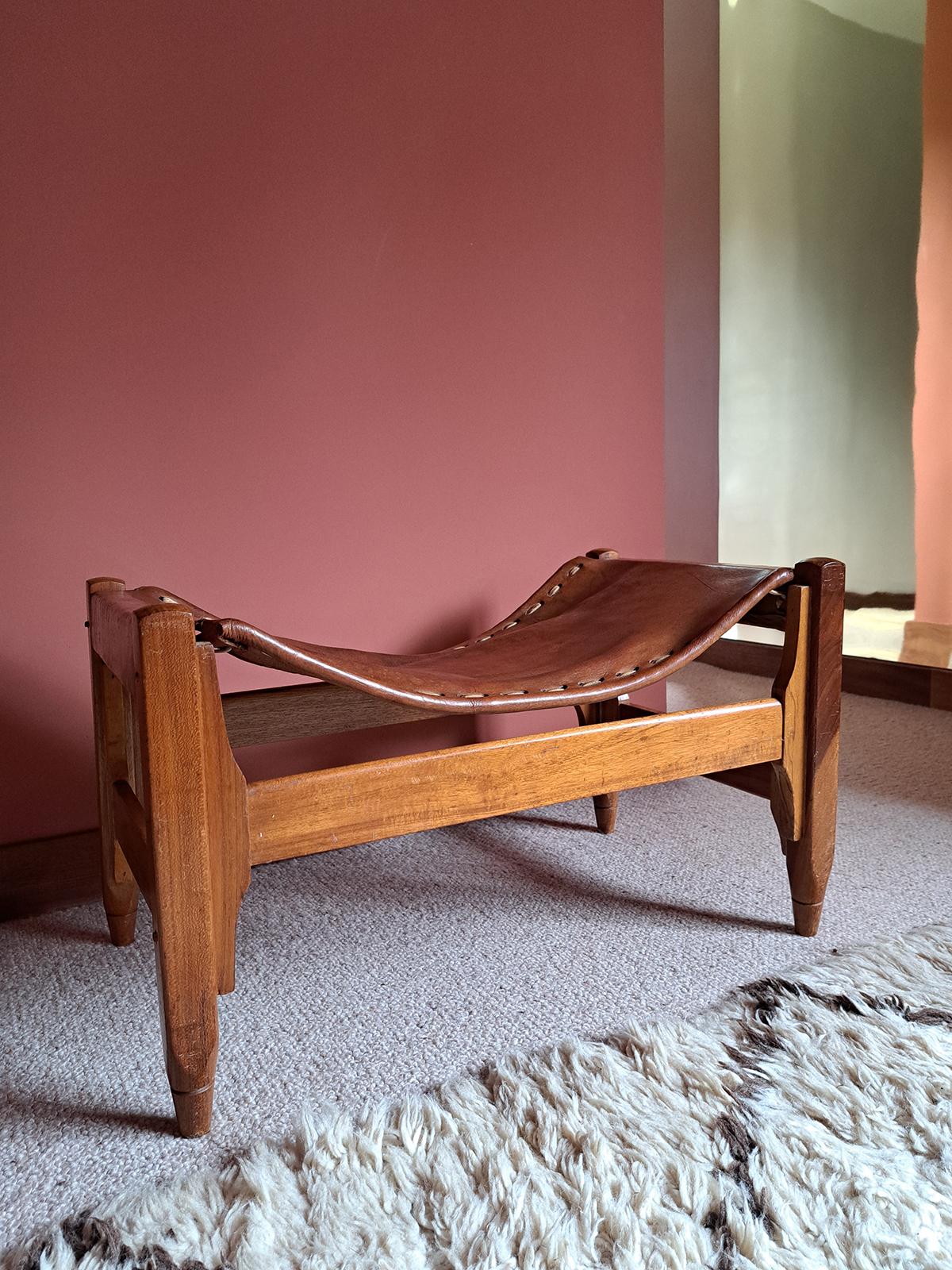Low leather stool designed by Werner Biermann in the 1960s and produced by Arte Sano in Colombia. A four-legged structure connected by a spacer, entirely in teak. The seat IS made with pieces of stretched brown leather and lasser with white leather