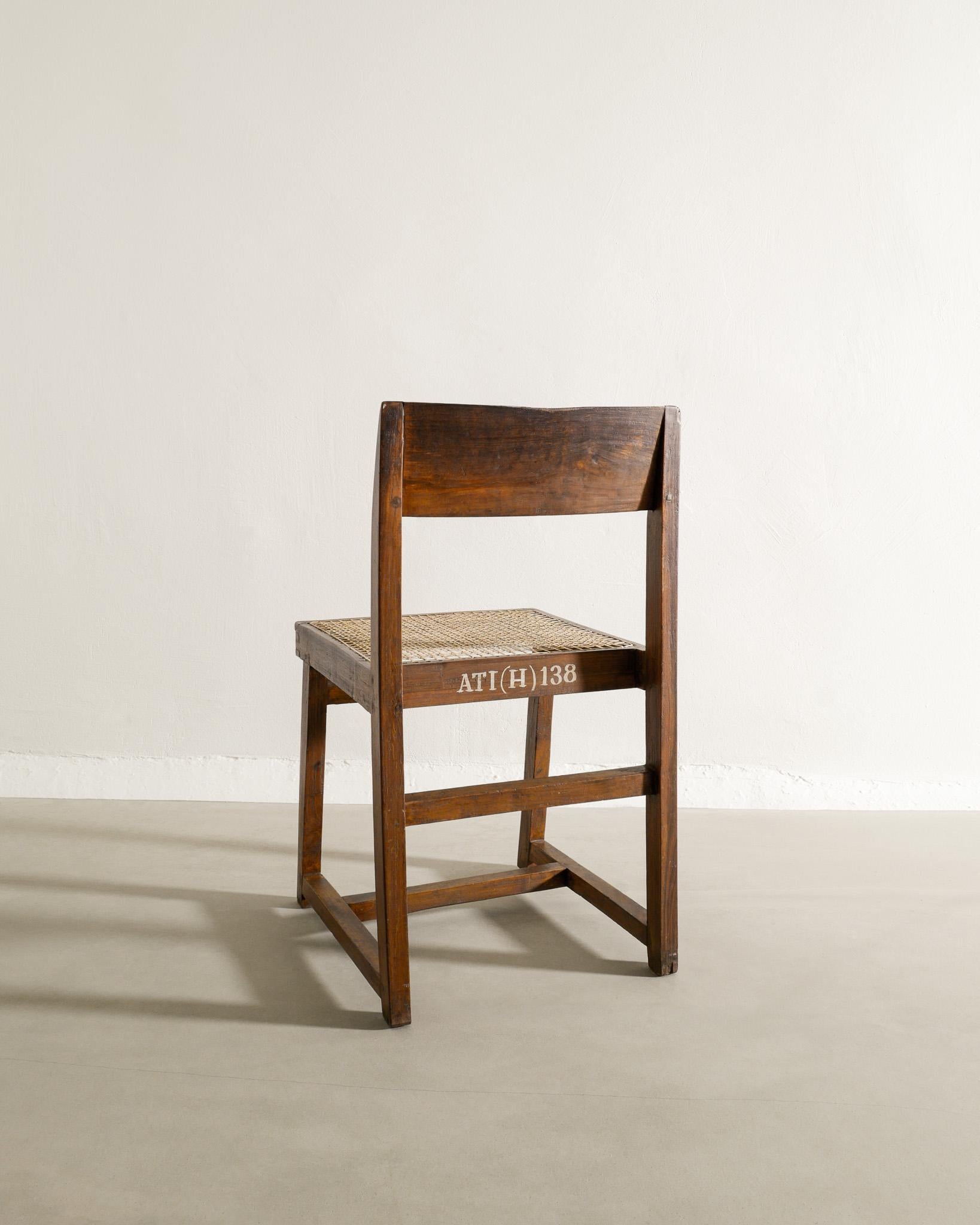 Rare mid century wooden dining office chair in teak and rattan by Pierre Jeanneret / Le Corbusier for Chandigarh India, 1950s. In good vintage and professionally restored condition. The cushion is included in the purchase. 

Dimensions: H: 78 cm /