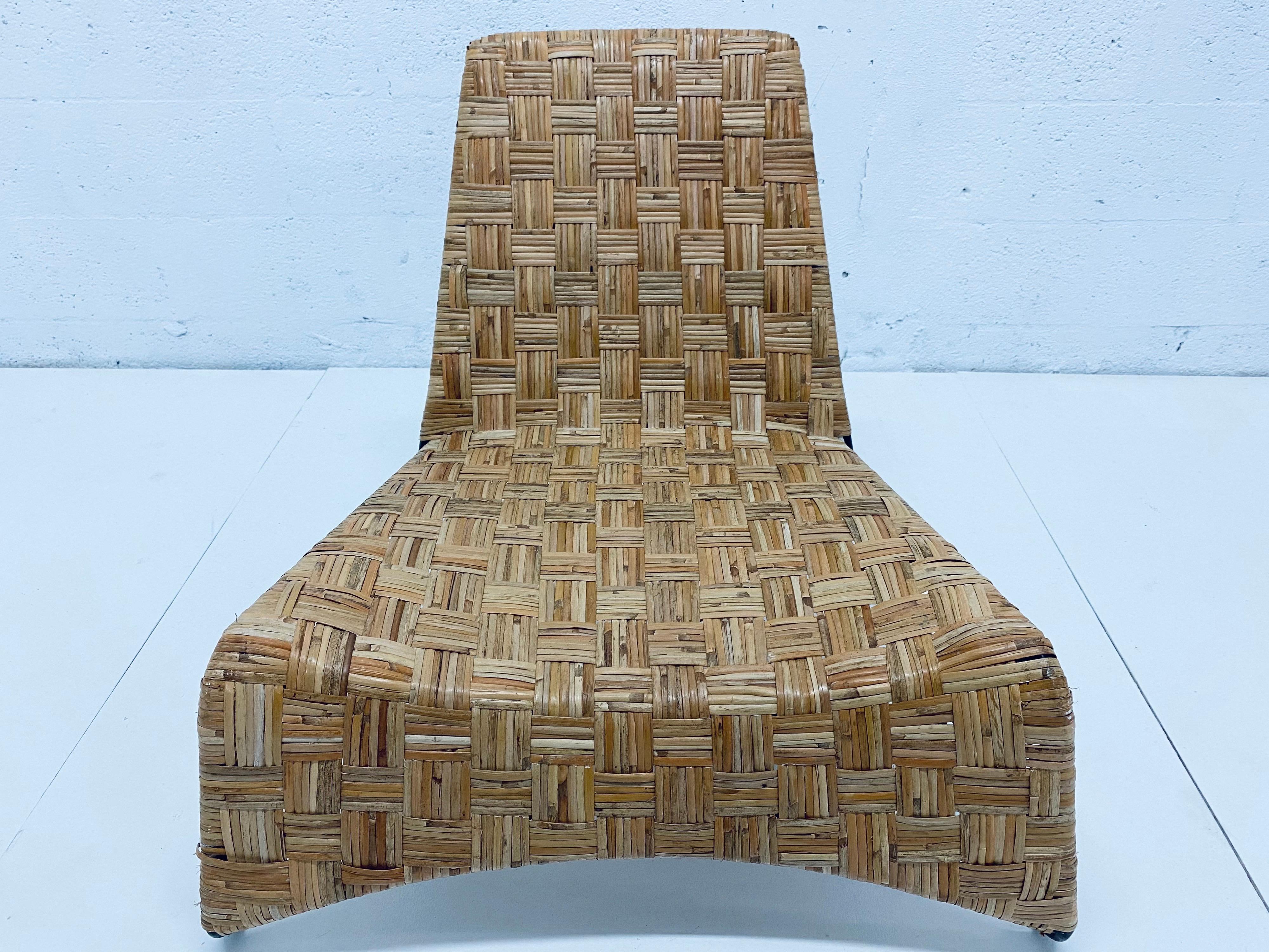 Midcentury 1970s woven rattan lounge chair with black tubular steel frame.