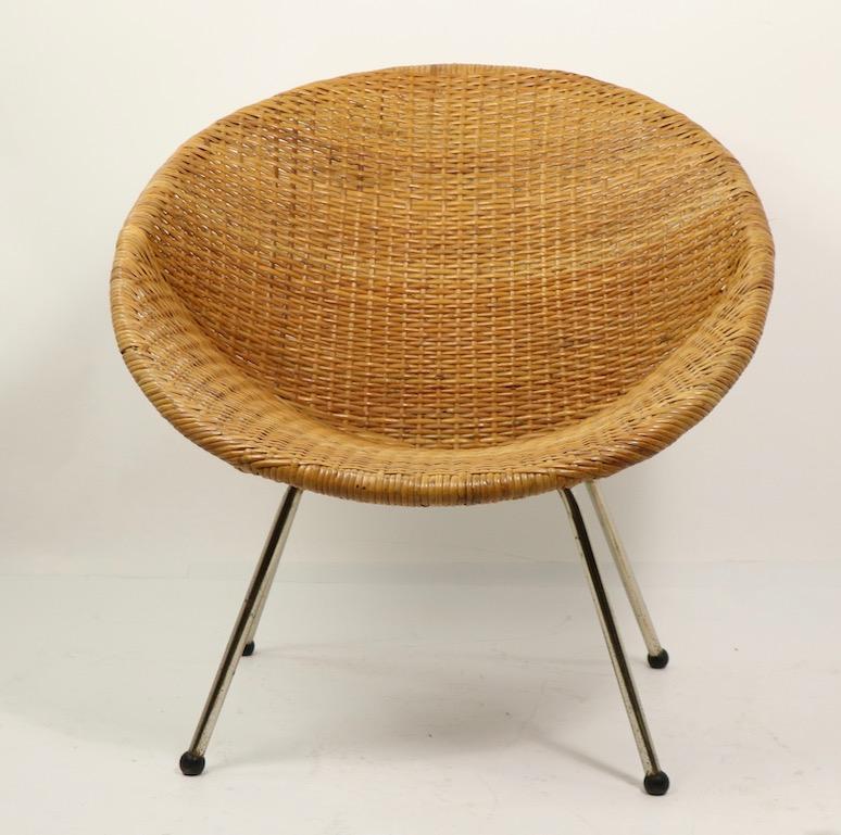 Midcentury wicker chair by Tropic Cane, having a continuous wicker shell form seat and back, and tubular chrome legs with black plastic ball feet, chrome legs show some rust on the surface, wicker have minor (inconsequential) loss, please see