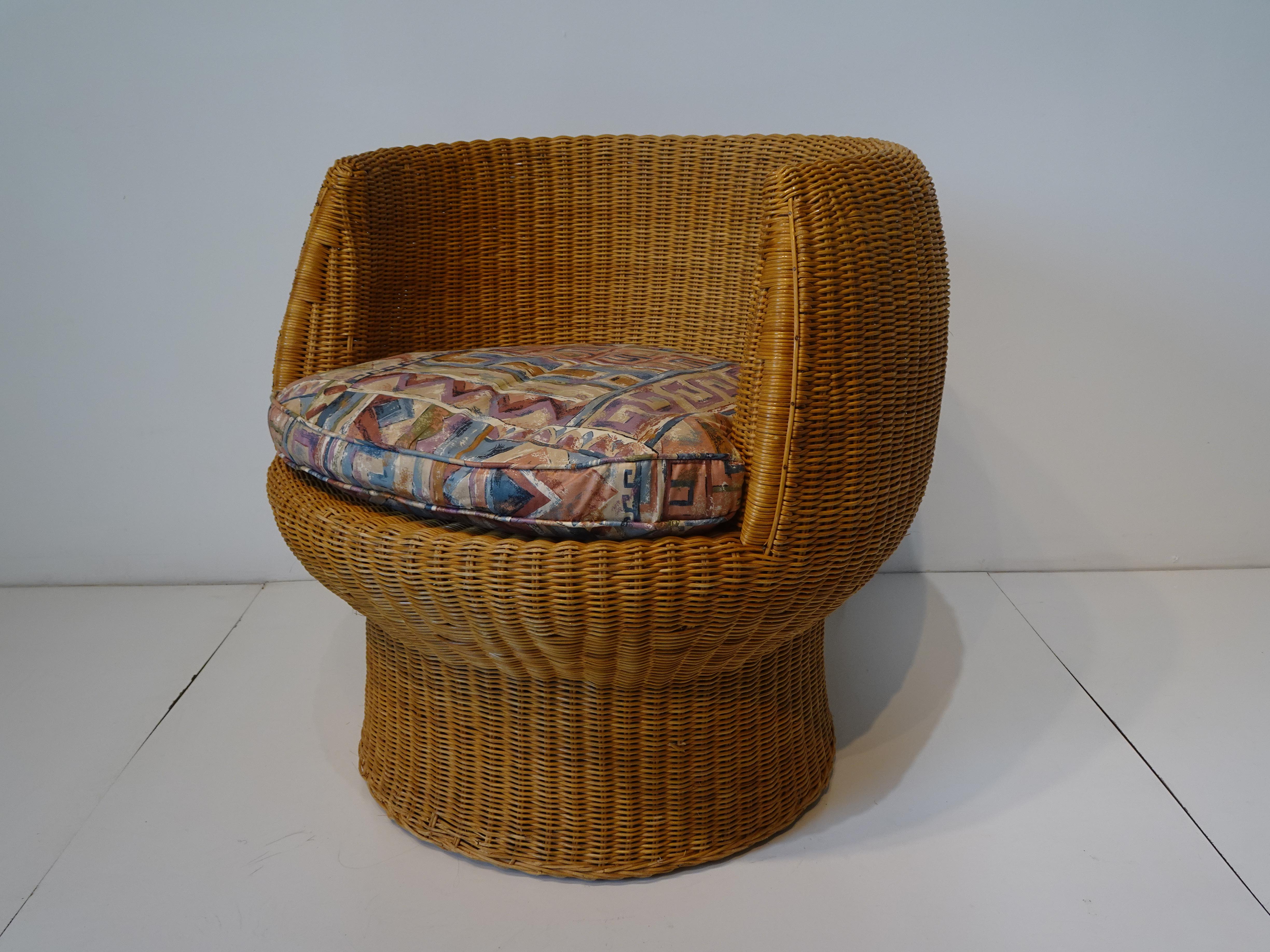 A mid century woven wicker chair in the style of the Cognac VSOP lounge chair by Eero Aarino with tight design lines . The chair is super comfortable with the arm rests at the perfect height and the great foot position , comes with a cushion that