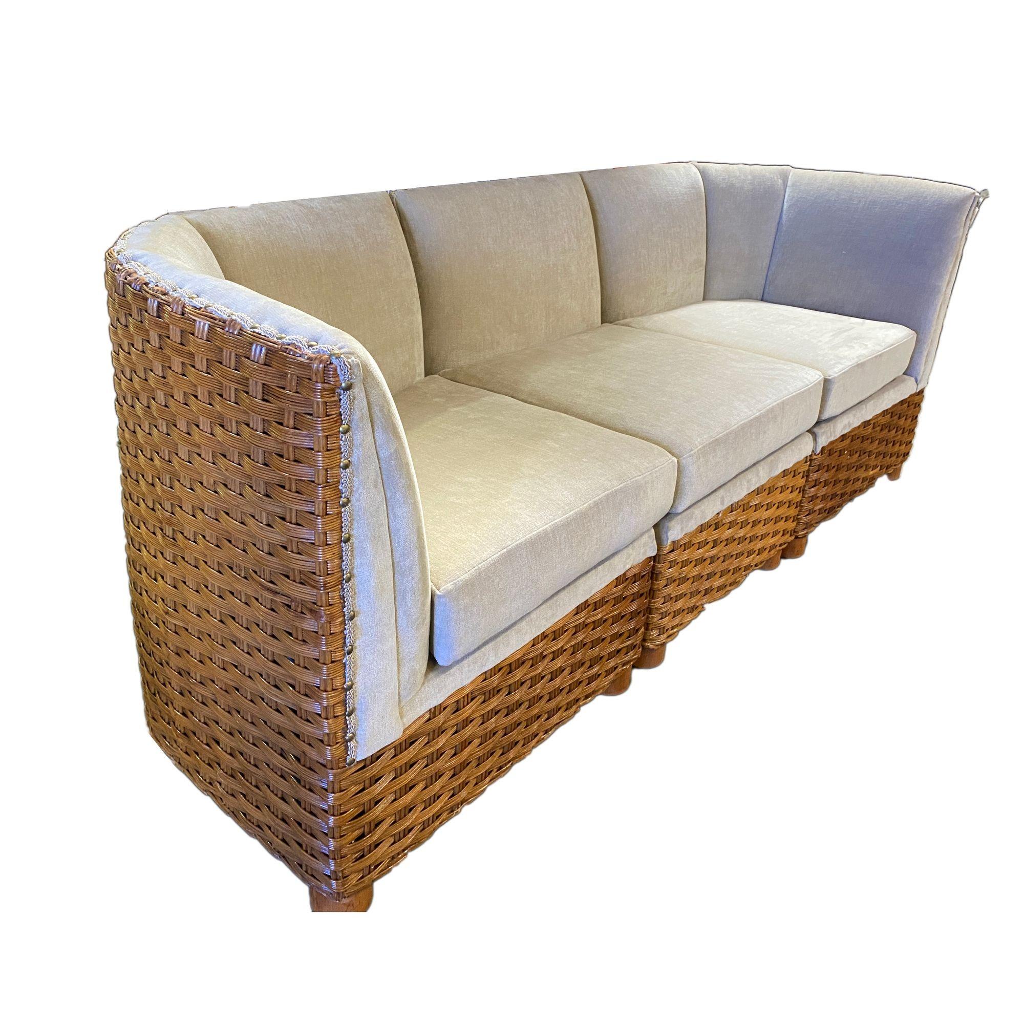Original pair of 1950s sectional woven wicker dinner booths each featuring a woven wicker body into 3 different sectional pieces. Each piece feature hand-woven wicker forming an oversized back with a new white textured broad cloth finish with brass