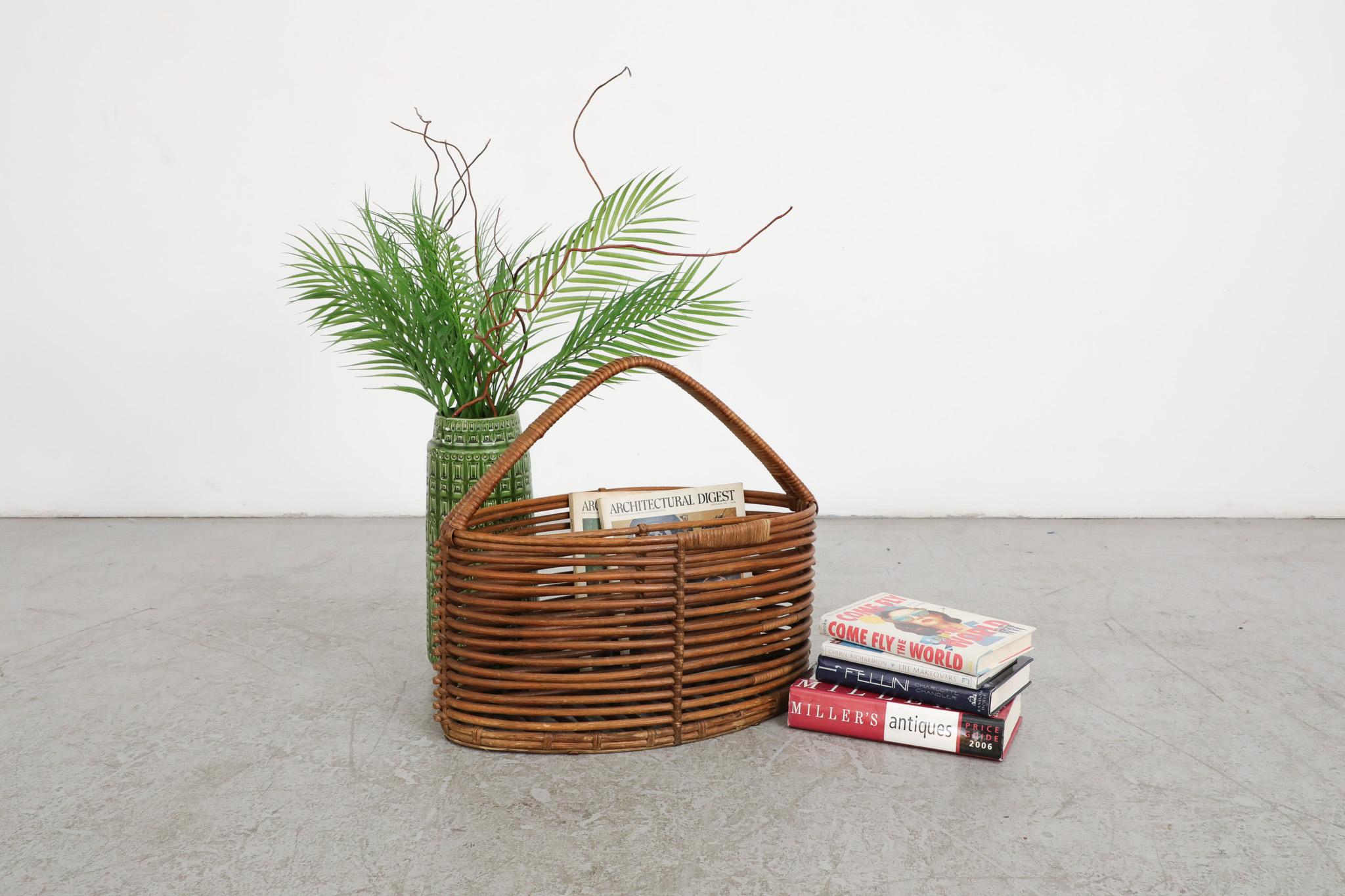 Beautiful, Mid-Century, hand-woven basket with handle made from young willow branches.  When used fresh, they are flexible and subsequently harden - which makes for a sturdy frame. This technique was and is commonly used to build fences in the