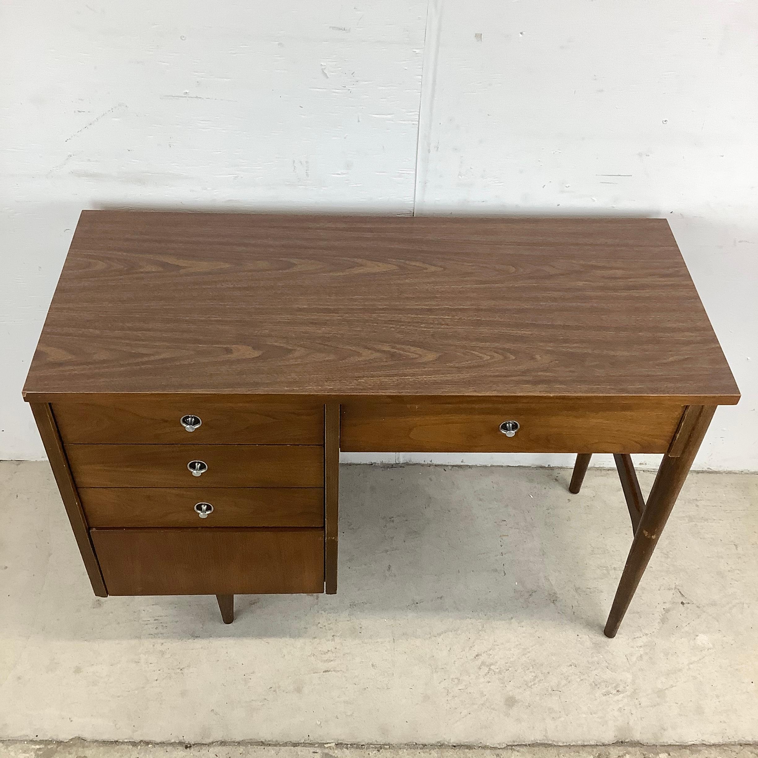 This Vintage Writing Desk by Bassett Furniture offers a charming touch of practical mid-century style to any space. More than just a workspace this petite vintage desk is not just a functional addition to your home office or study space; it offers a