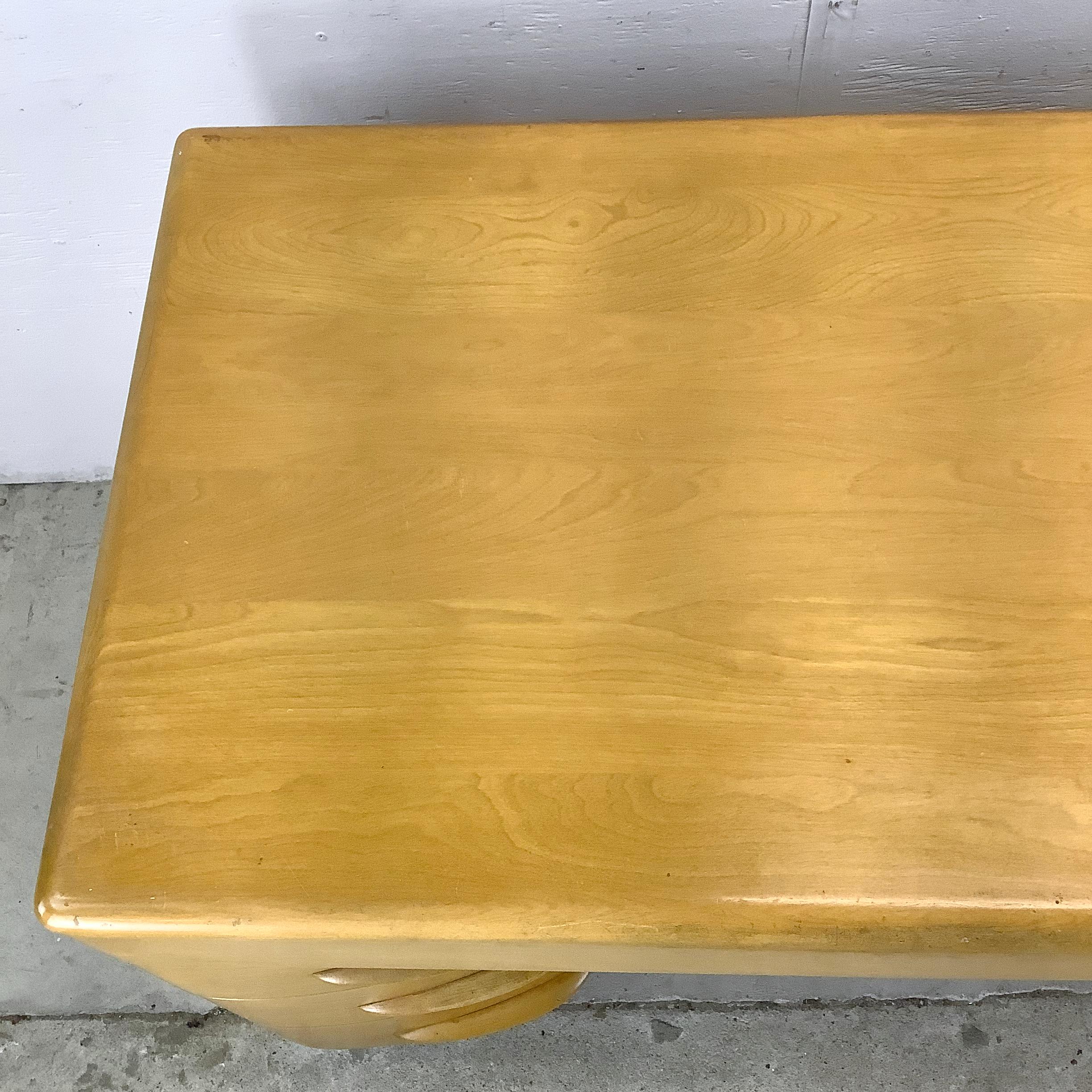 Crafted by the iconic Heywood Wakefield, this Six Drawer Maple Writing Desk is the perfect blend of style and functionality. Made from solid maple, the desk offers a rich, natural wood finish that will enhance any room with its mid-century modern
