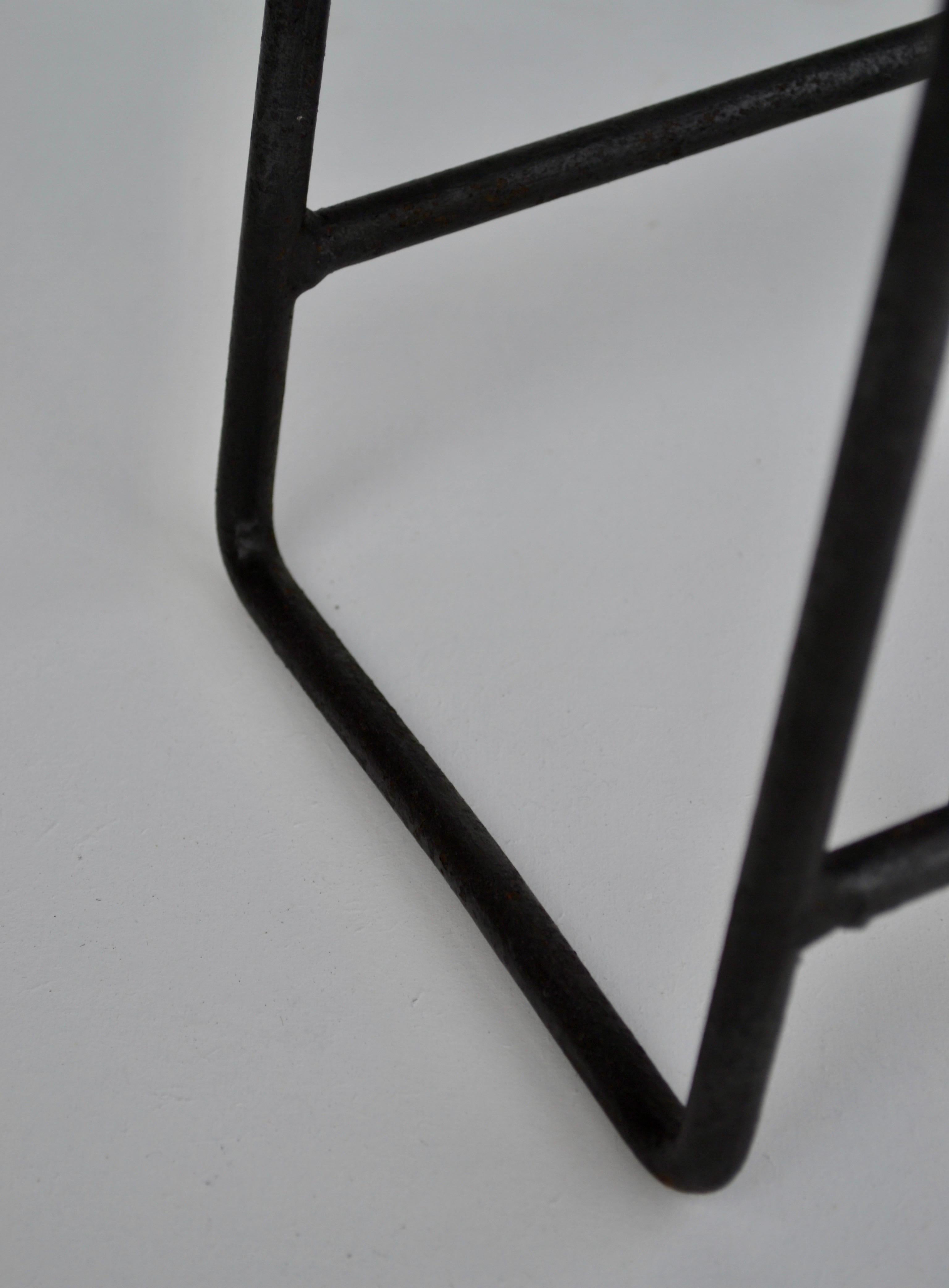 Attributed to Jacques Adnet


A Stylish French umbrella stand from the 1950s, crafted from black wrought iron and accented with twisted brass wire. The sculptural, geometric frame reflects the refined simplicity and craftsmanship of mid-century