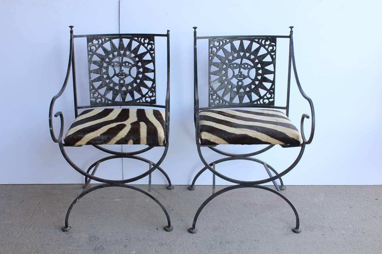 Midcentury wrought iron and cowhide sunburst armchairs by Arthur Umanoff. Measure: Seat H 19