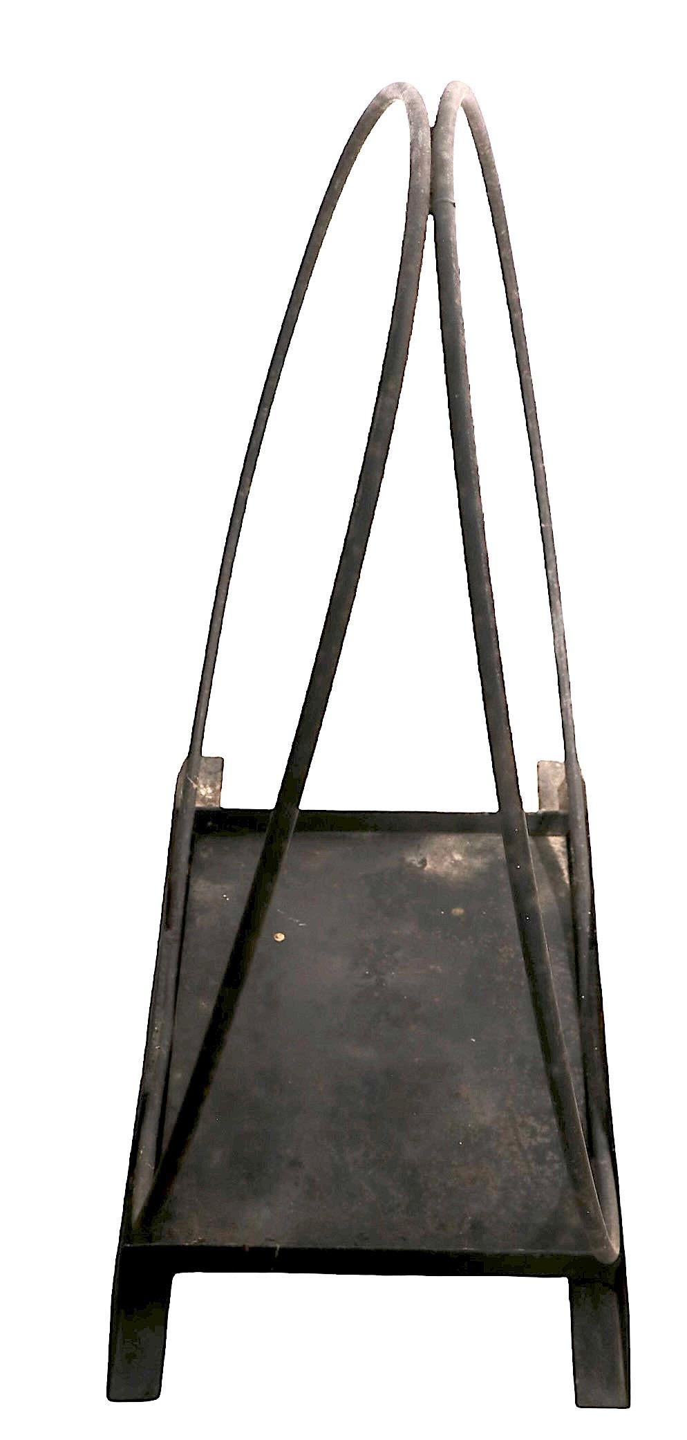 Well crafted wrought iron mid century log holder with unusual steel tray base. Nice medium scale dimensions make this log holder perfect for either indoor or outdoor use.