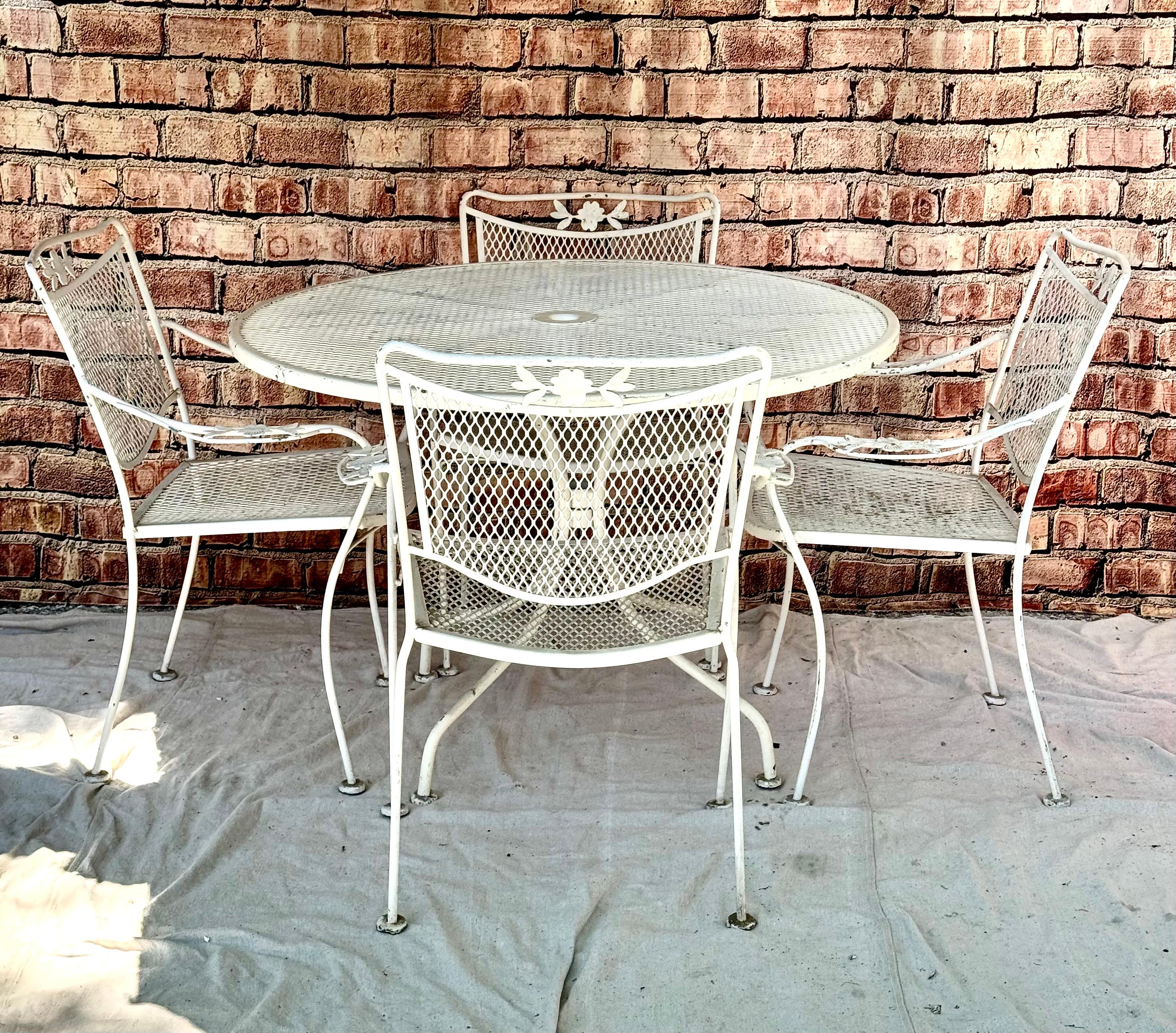Five piece Mid-Century Wrought Iron Patio set in the style of Salterini. Featuring table and four chairs. 42