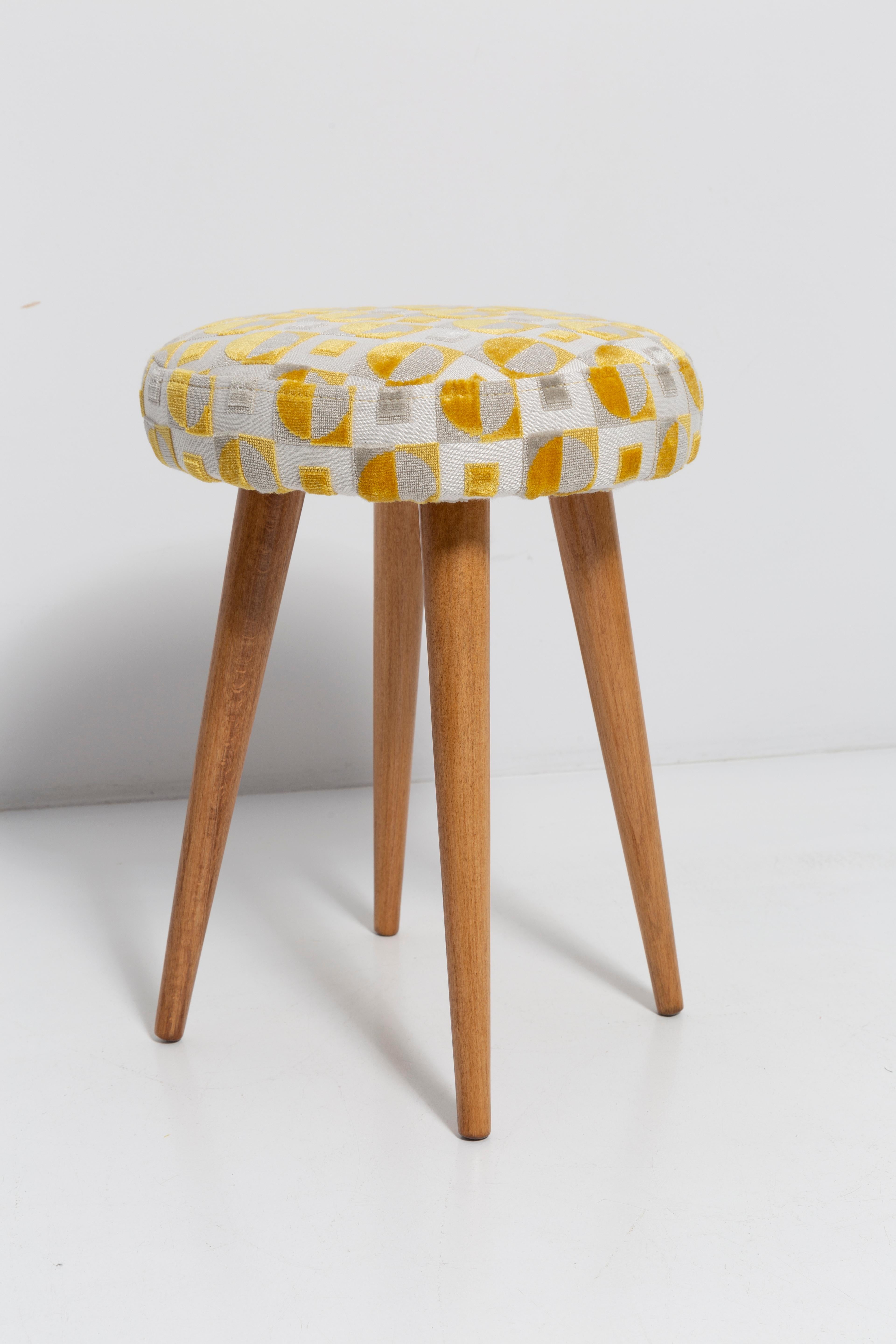 Stool from the turn of the 1960s and 1970s. Beautiful beige and yellow upholstery. The stool consists of an upholstered part, a seat and wooden legs narrowing downwards, characteristic of the 1960s style. We can prepare this pair also in another
